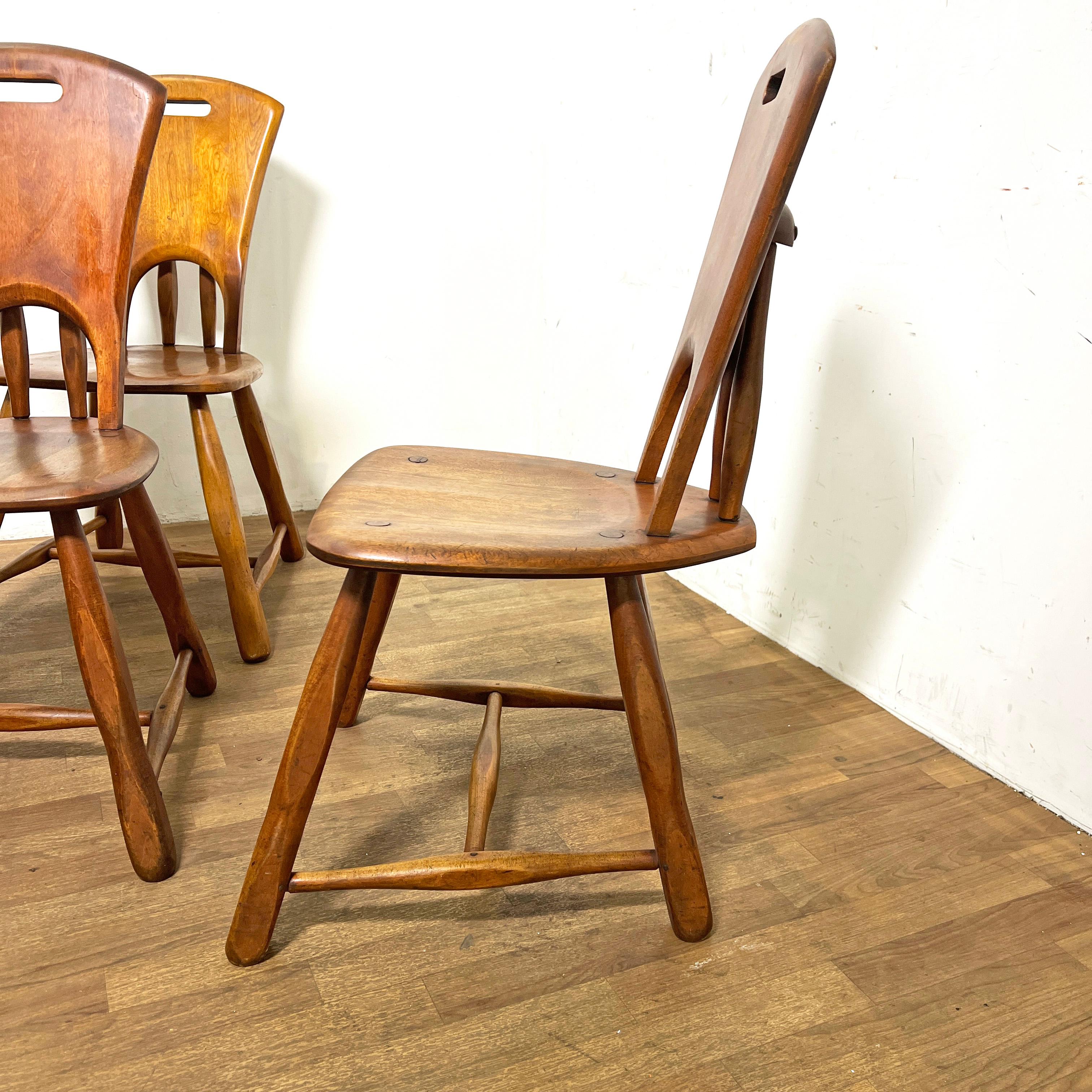 A set of ten American rustic side chairs crafted in hard rock maple. Their distinctive russet finish and chamfered wagon spoke legs are reminiscent of the early to mid 20th century designs of Cushman in Vermont or Wylie R. Dallas of Texas but we