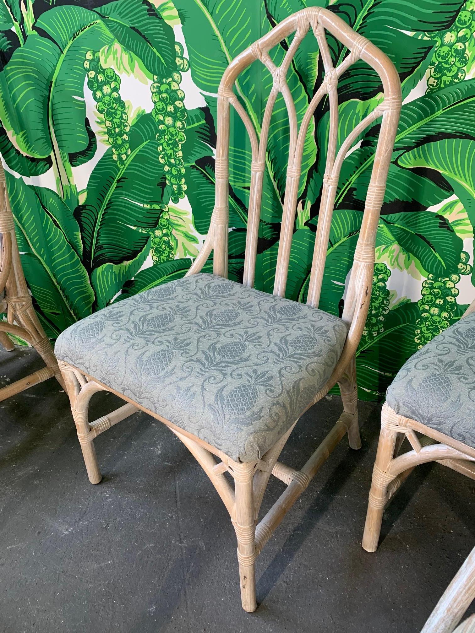 Set of 10 rattan dining chairs by Henry Link in excellent structural condition with minor abrasions consistent with age. Four of the chairs have a different upholstery. Faux bamboo look with leather wrapping. One chair has one spot where leather