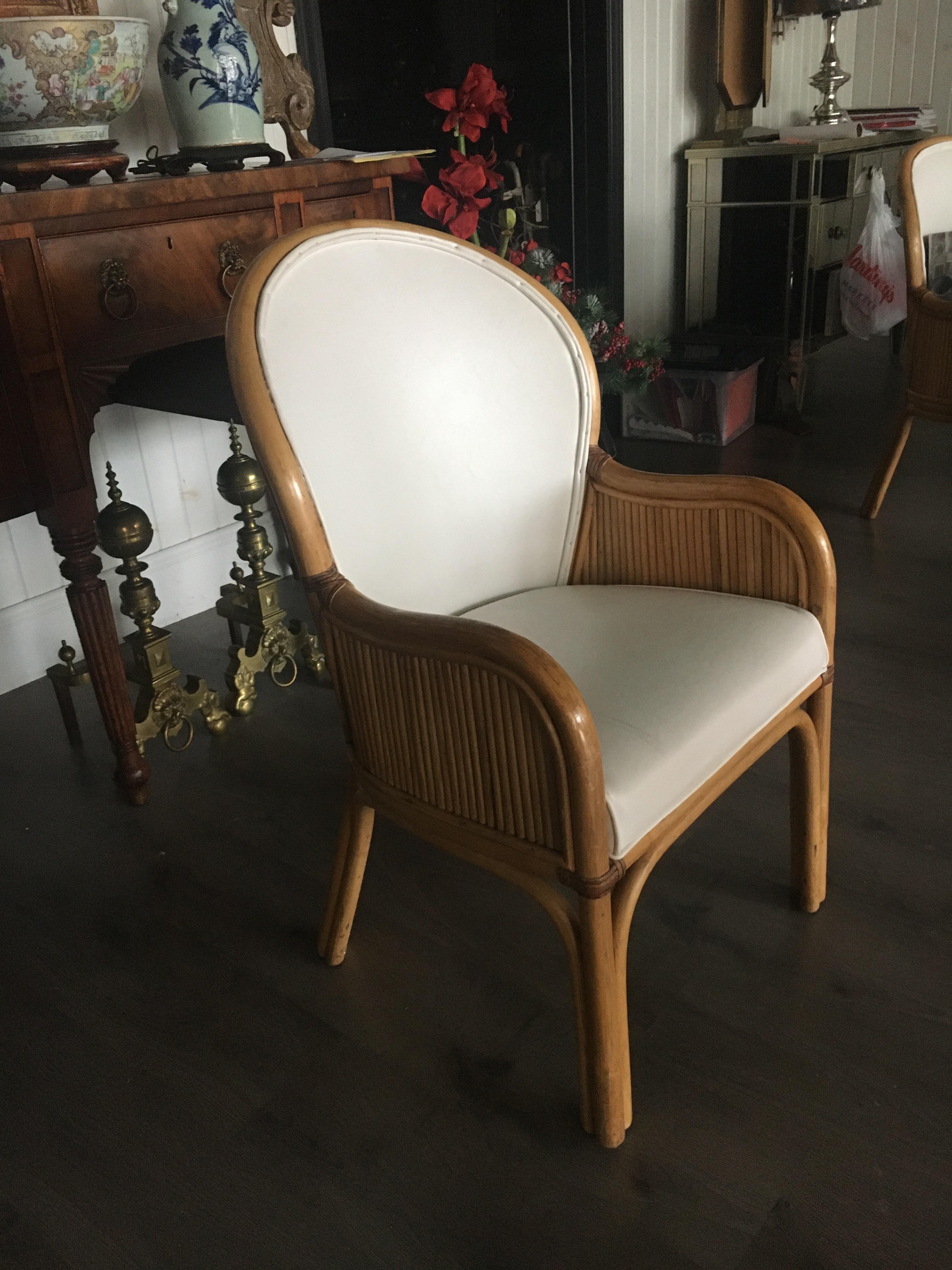 Set Of Ten Rattan frame chairs with white upholstery. Rattan frame chairs with white
upholstery In the style of McQuire.  We also have a large selection of mid century chairs, feel free to call or email with questions.
