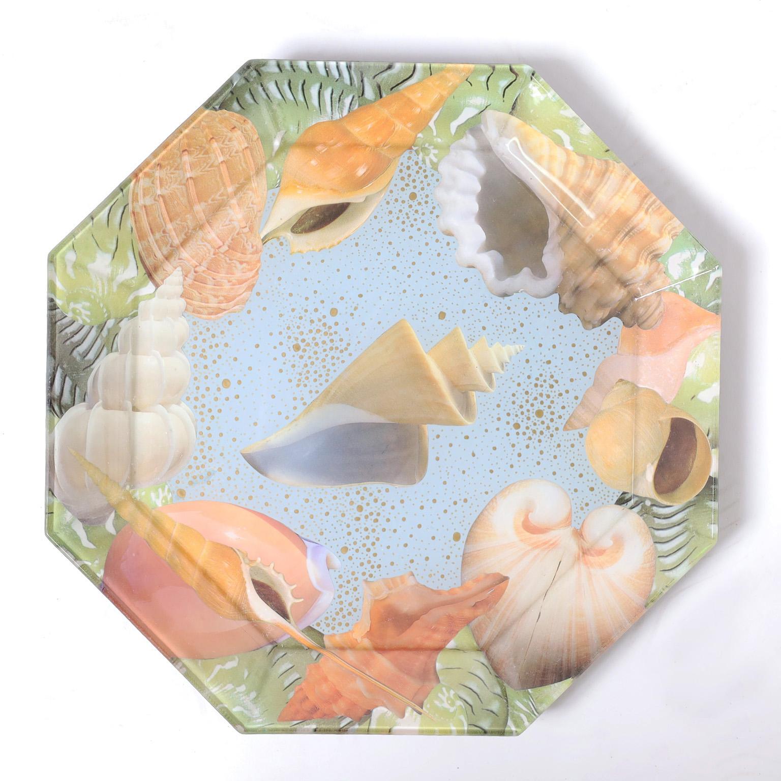 Eye catching set of ten glass plates with an octagon form decorated with seashells in a whimsical reverse decoupage technique.