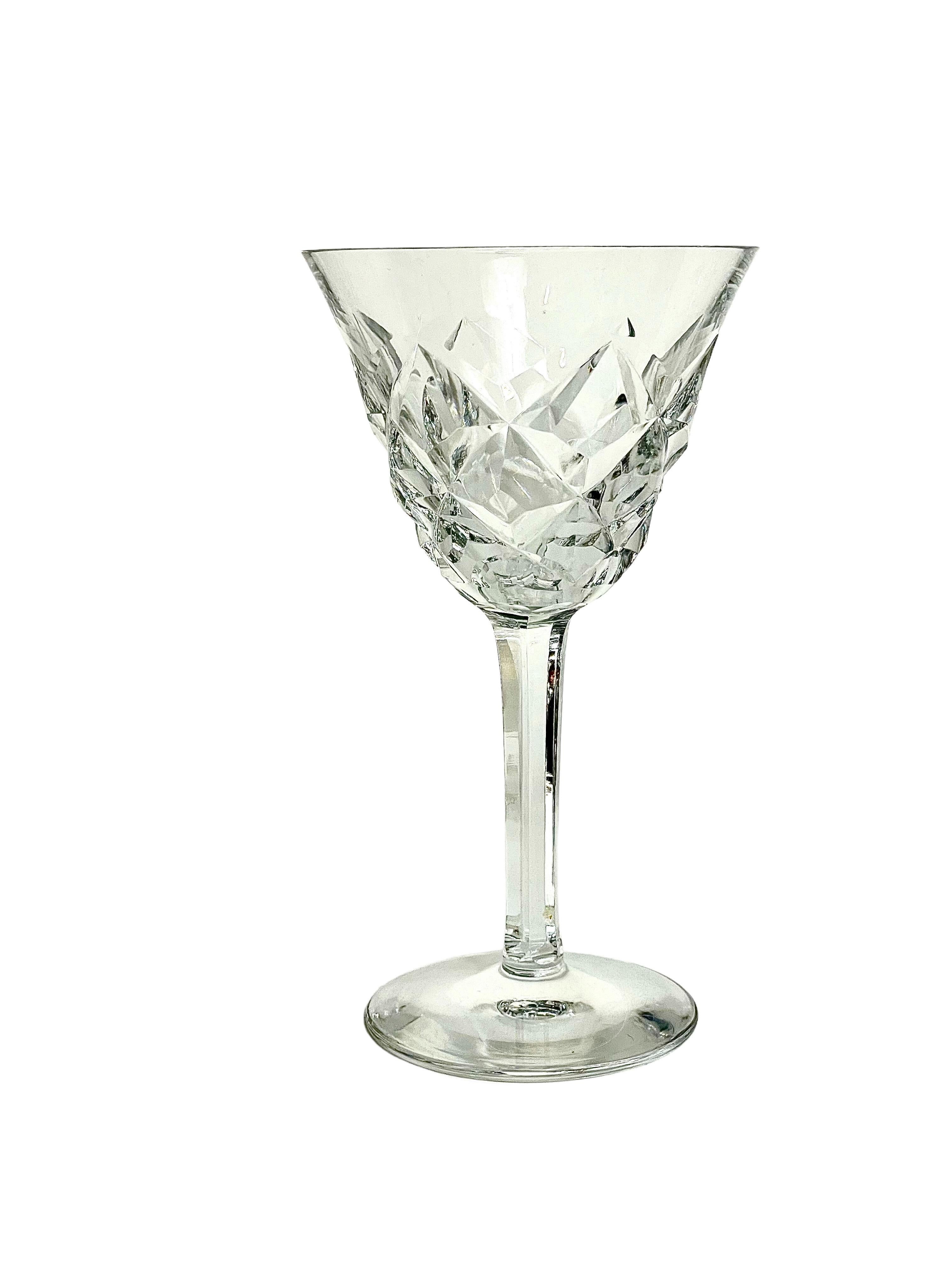 A sparkling set of 10 fine crystal wine or water glasses, by Saint Louis, from the 'Adour' pattern series. Dating from around 1950, these timeless glasses feature the classic Adour 'cross cut diamond' design on their body, with faceted stems and