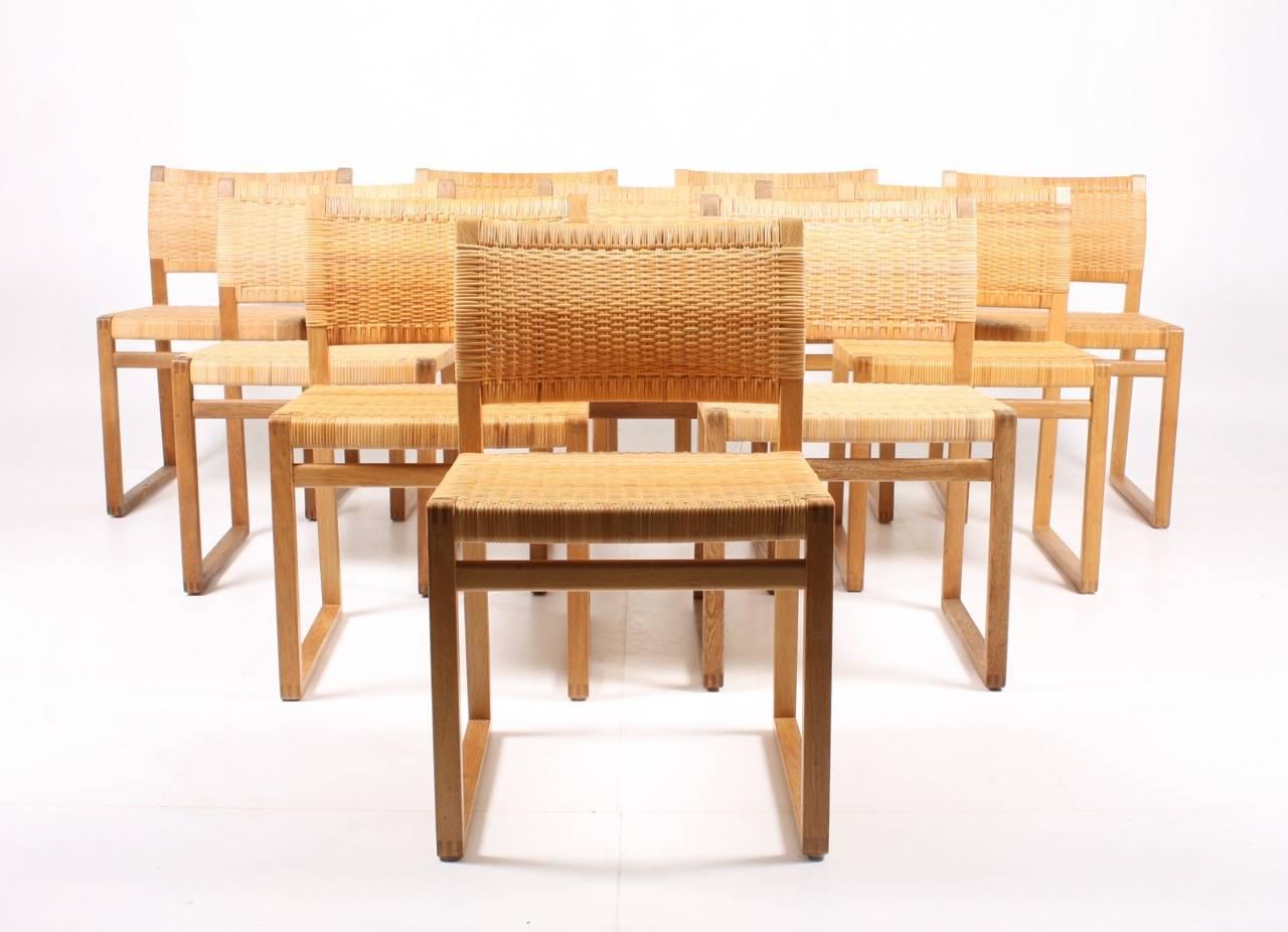 A set of ten Scandinavian side chairs in solid oak with cane woven seat and back. Designed by Børge Mogensen for P. Lauritzen, Denmark. Great condition.