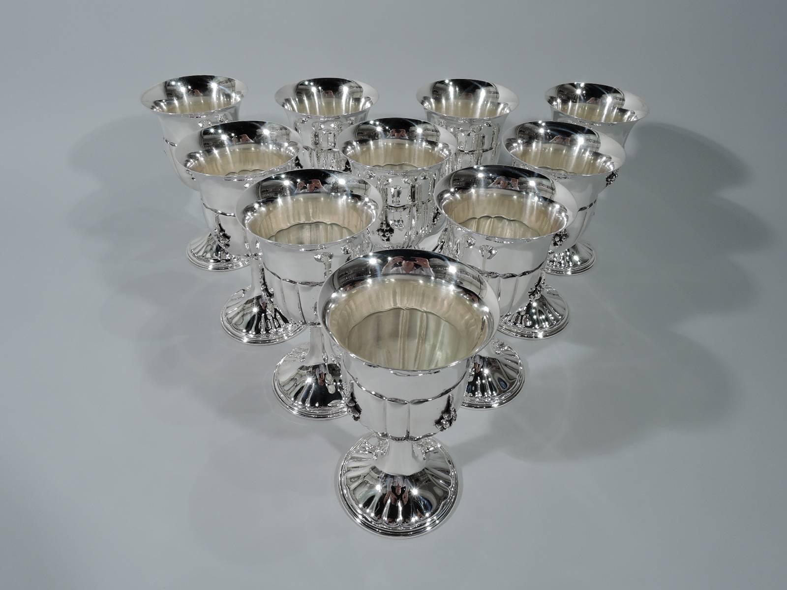 Set of ten stylish sterling silver goblets. Made by Ugo Bellini in Florence, Italy. Each: Bowl has flared rim and alternating wide and narrow lobes with applied pendant fruit clusters. Foot also lobed and stem cylindrical. Hallmarked. Total weight: