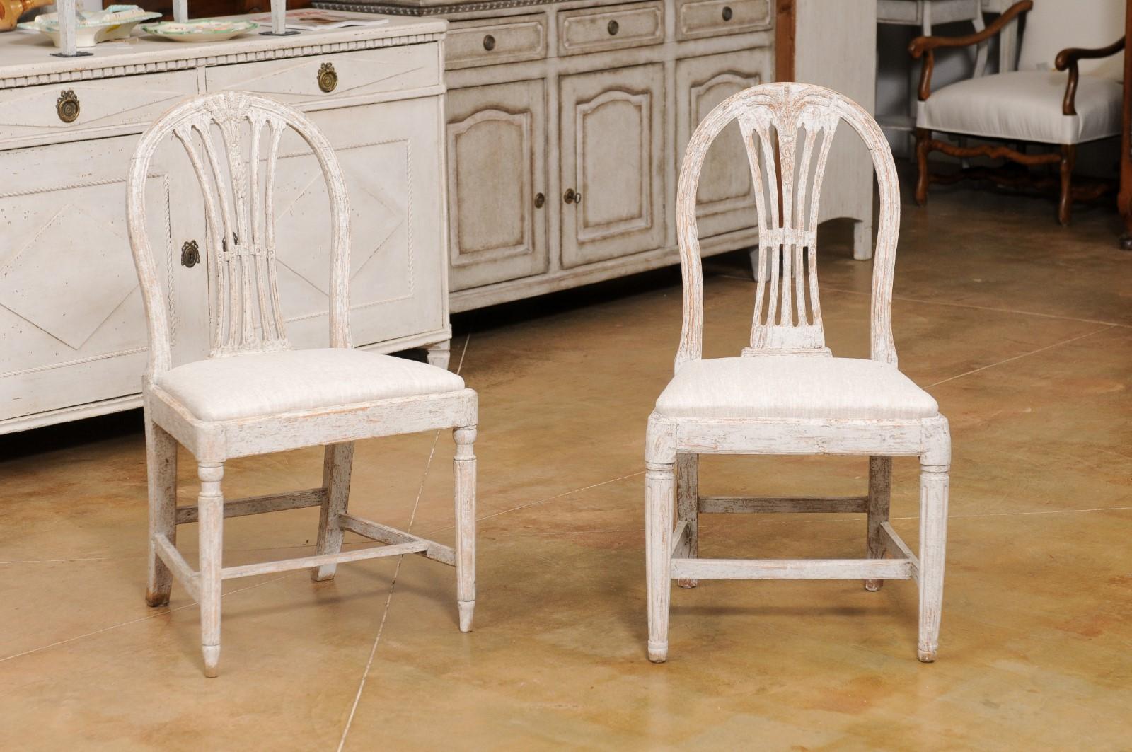 A set of ten Swedish Gustavian wheat back dining room side chairs from the early 19th century, with distressed finish and new upholstery. Created in Sweden during the early years of the 19th century, each of this set of ten chairs features a wheat