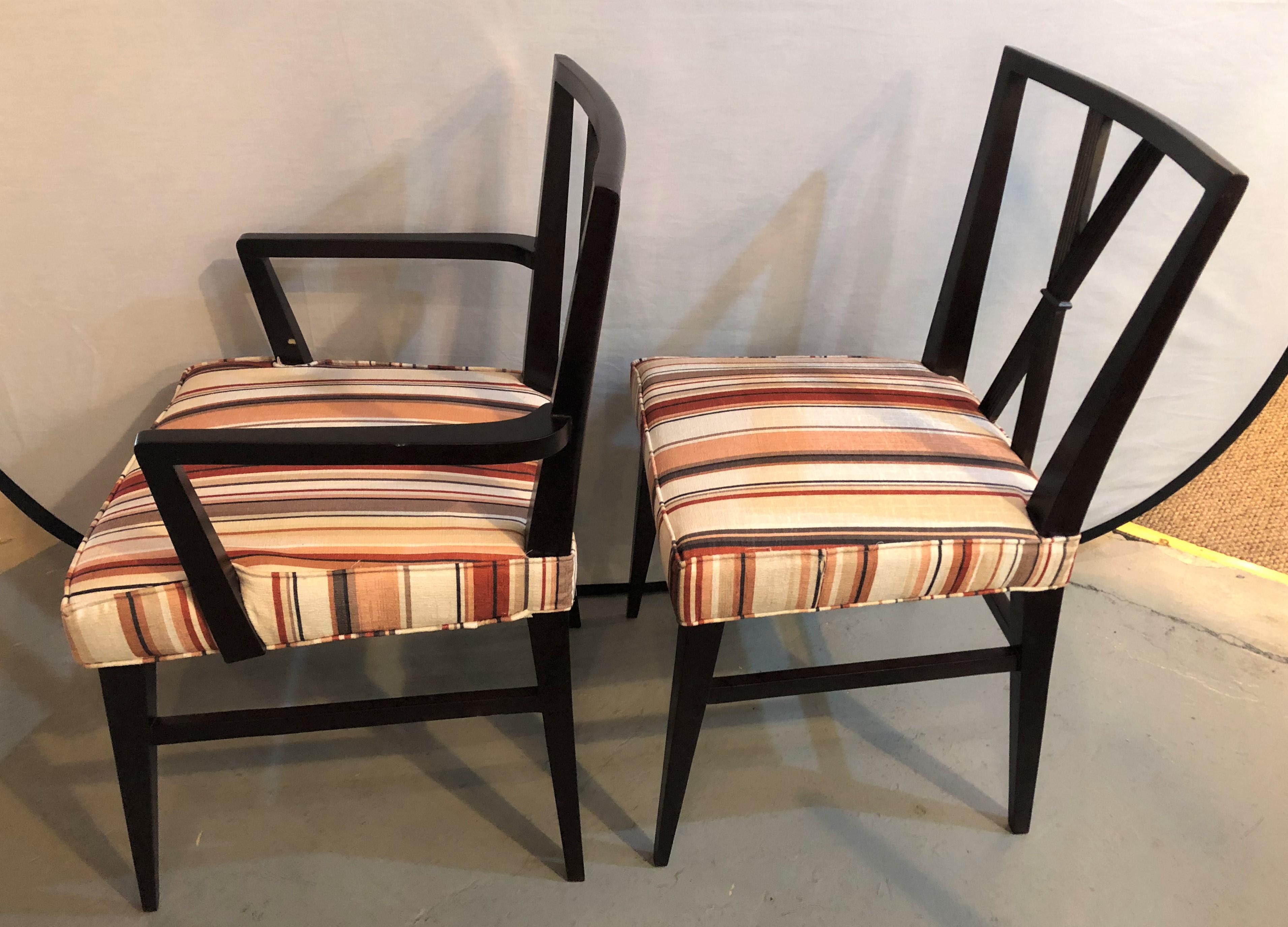 Set of ten Tommi Parzinger attributed dining chairs. Each in very nice condition with new upholstery. The set with X backrests leading to overstuffed and very comfortable seat rests on sprayed legs. All strong and sturdy.
The arm chairs measure