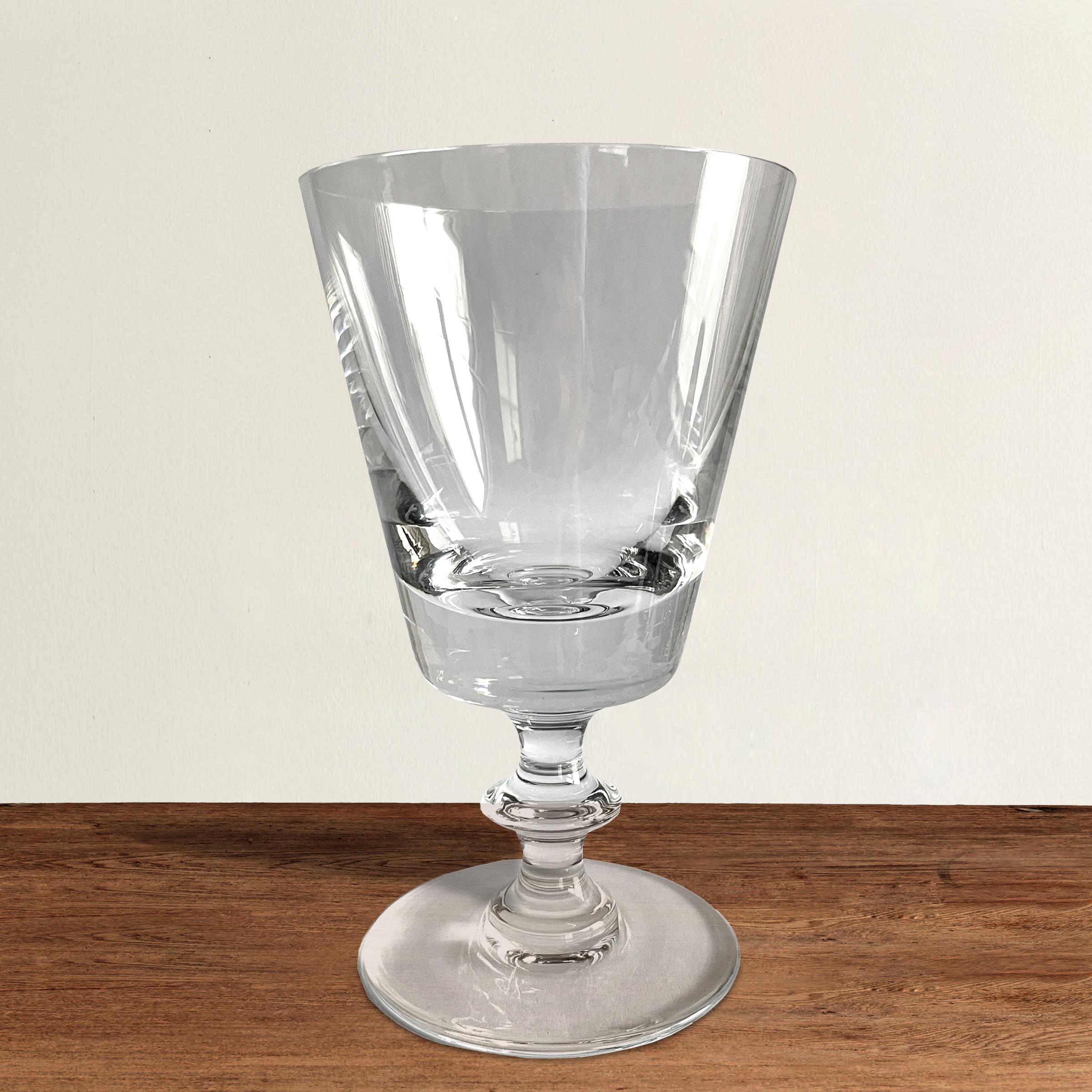 A covetable set of ten blown crystal wine glasses by famed Belgian crystal company, Val Saint Lambert, in the State Plain pattern, each with a simple bowl with straight sides and a stem with a single knot and resting on a wide flat foot. Marked,