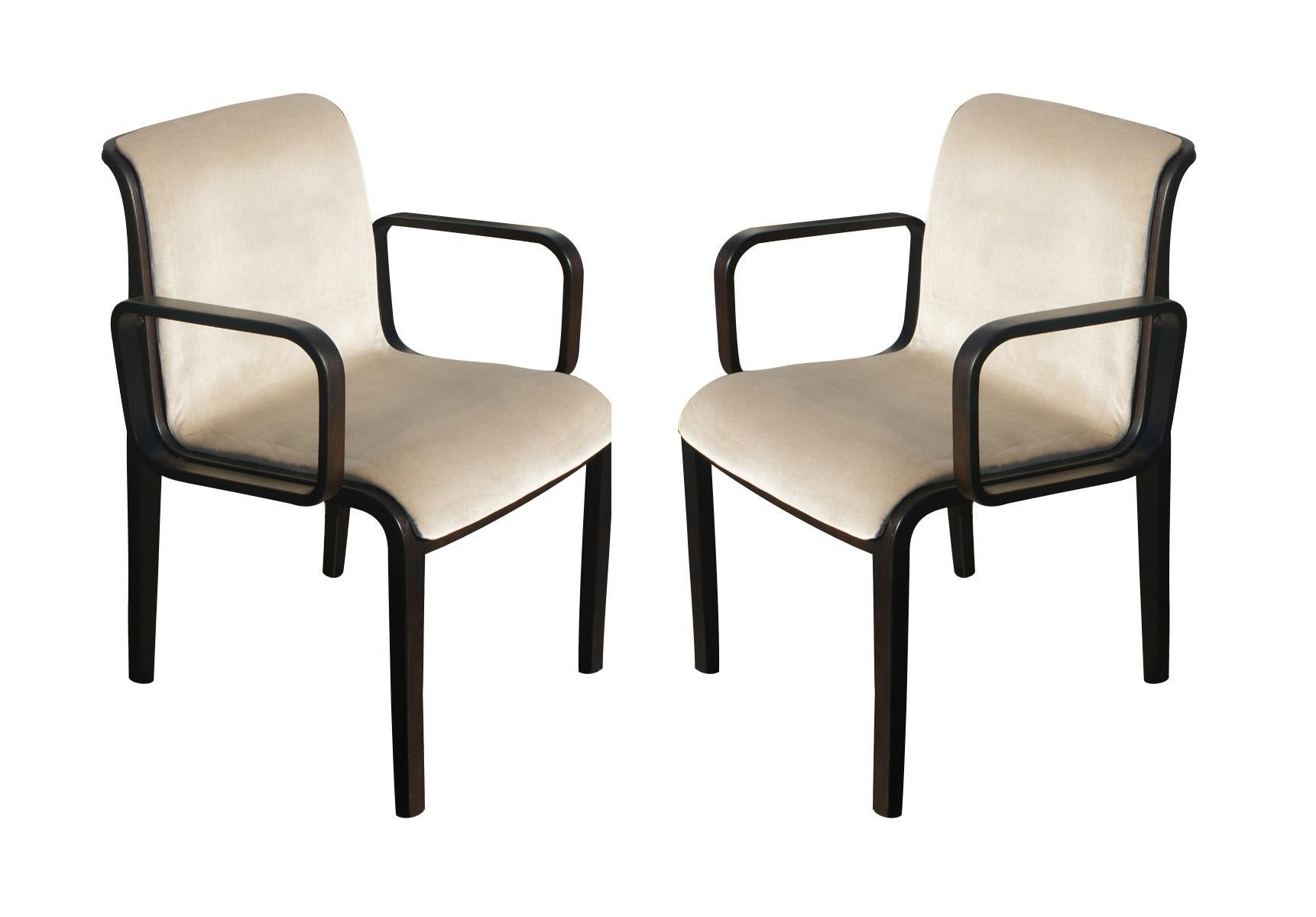 This vintage set of 1300 Series armchairs designed by William 'Bill' Stephens for Knoll. The unique style of Stephens feature gorgeous bent wood with a dark color stain, paired with beige upholstery. Marked to underside of frame.