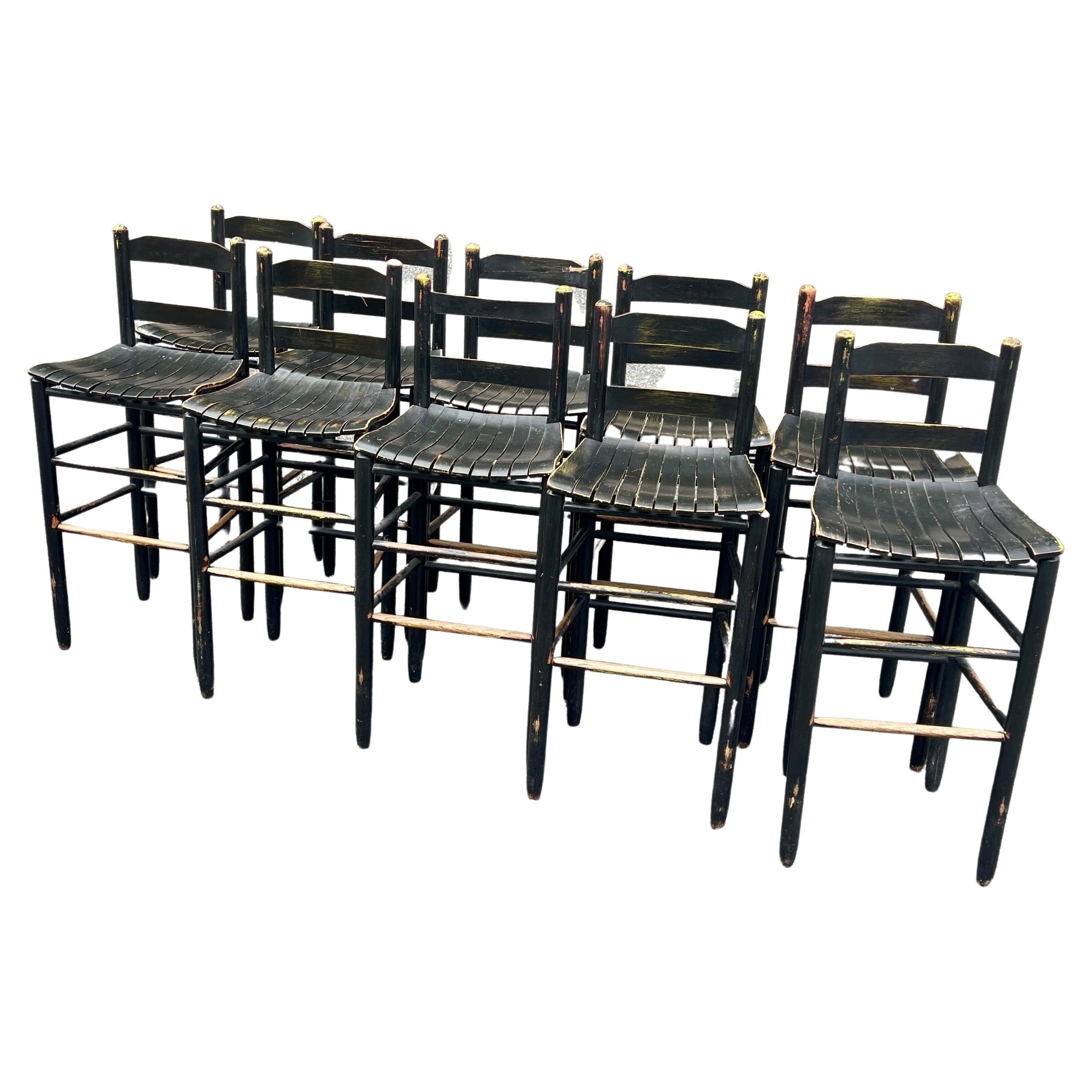 10 Mid-Century Modern Black Painted Bar Stools in Worn Patina Wood.
The stools has signs of an earlier yellow paint that has be overpainted by the current semi-glossy black paint.