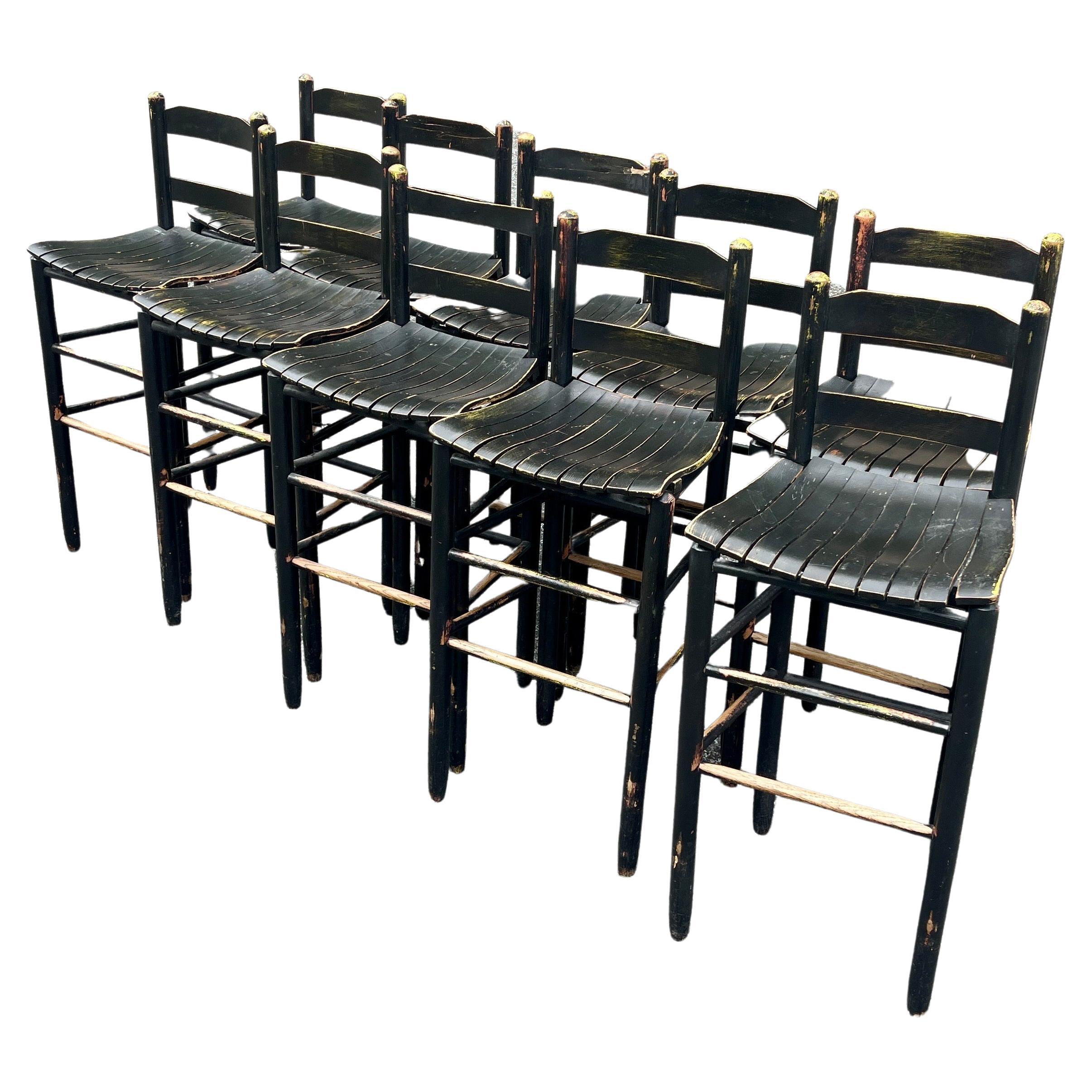 10 Taburetes de bar modernos de mediados de siglo pintados de negro en madera patinada desgastada.
El taburete tiene señales de una pintura amarilla anterior que ha sido sobrepintada por la pintura negra semibrillante actual.