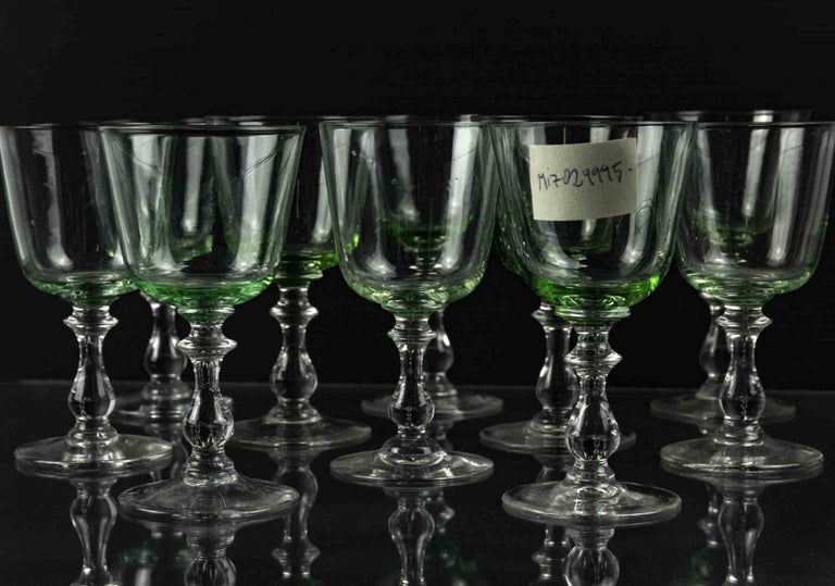 Set of ten glasses is an original decorative object realized in the 1970s.

Made in Italy.

The set includes ten green glasses with the neck and the base of the glasses are transparent. 

Total dimension per glass: 13 x 7 x 7 cm. 

Very good