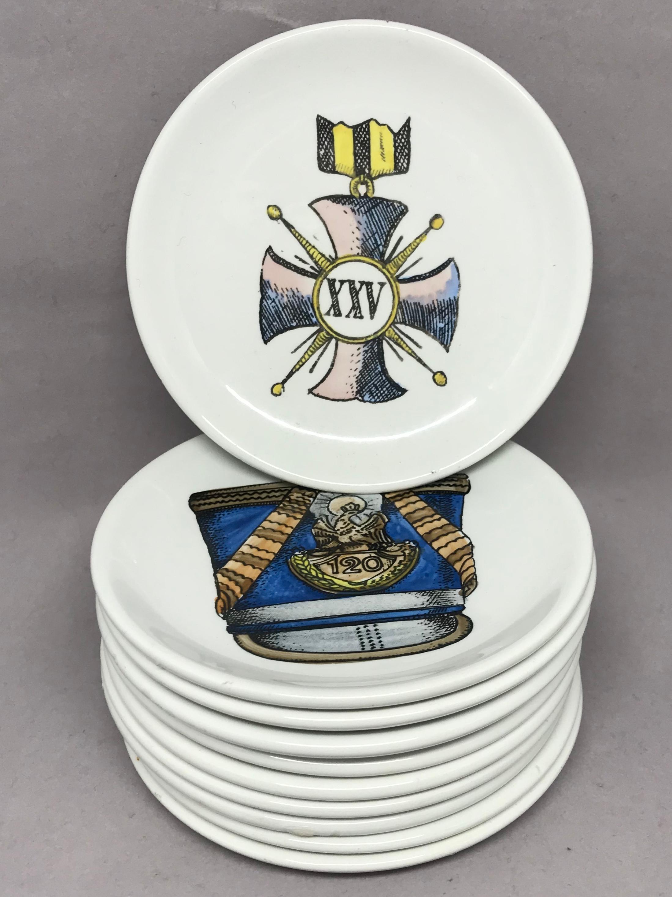 Set of ten vintage Italian porcelain coasters. Ten white drinks coasters with various hand-painted military hats and decorations, each marked Bucciarelli, Milano. Italy, circa 1960.
Dimensions: 4.25