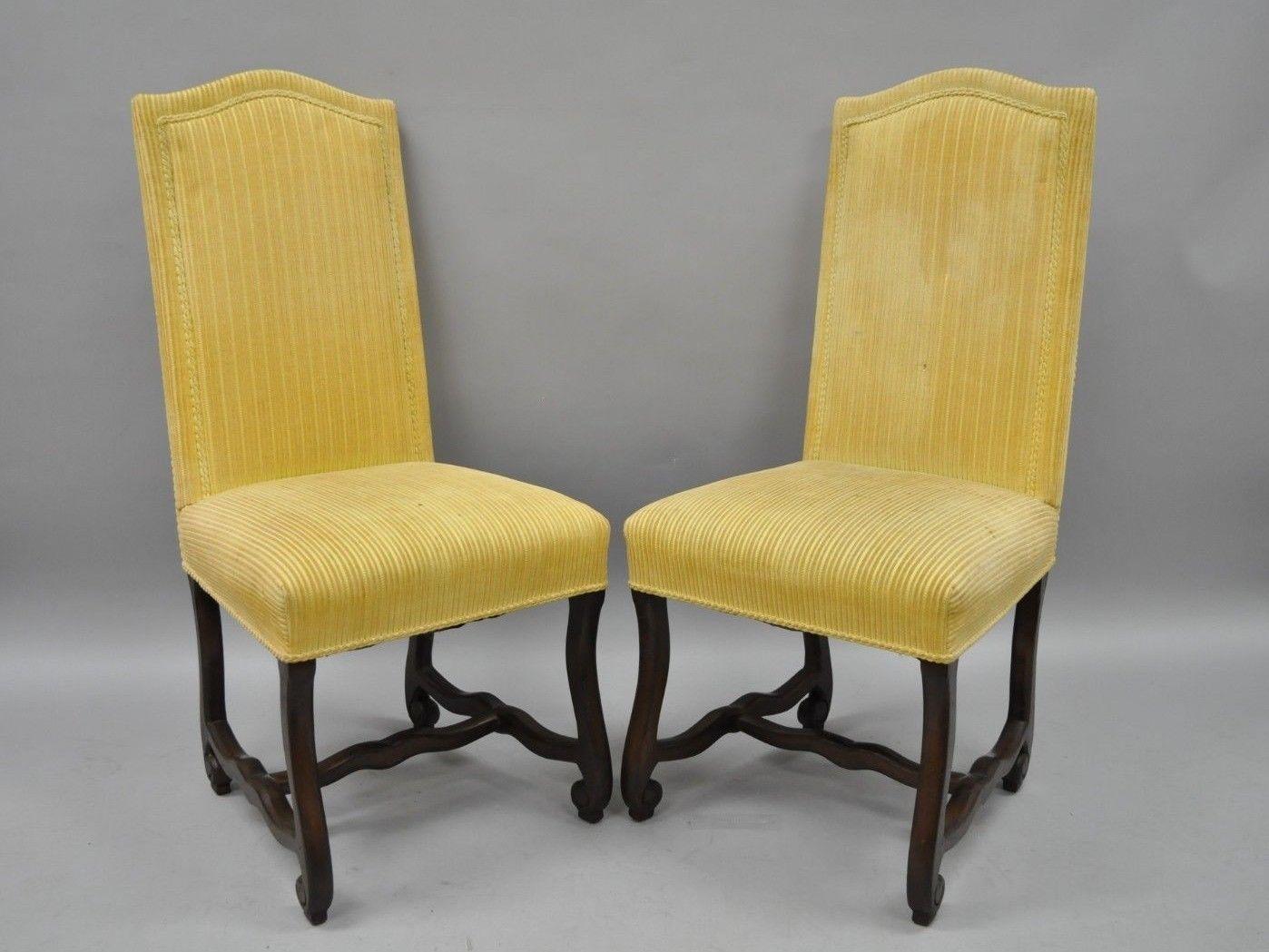 Set of ten vintage walnut Os De Mouton Louis XIV French style upholstered dining side chairs. Listing includes 10 armless chairs, solid carved wood frames, distressed finish, scrolling legs and stretcher support, fully upholstered seats and backs,