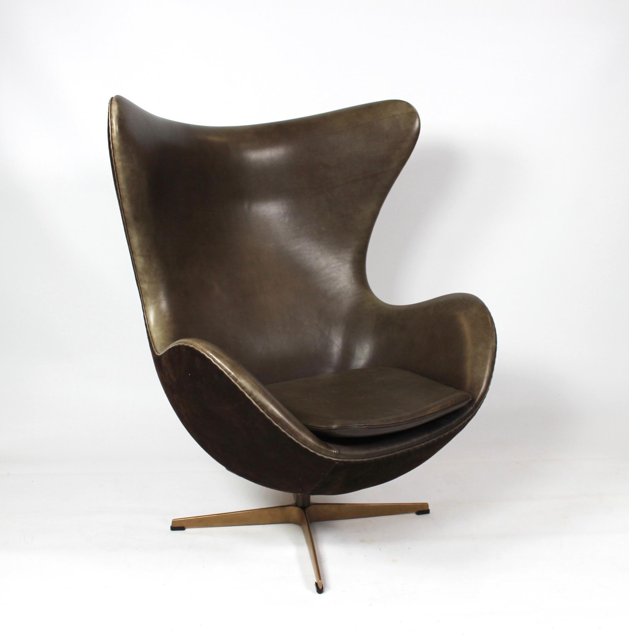 Set of the egg, model 3316, and matching stool designed by Arne Jacobsen 1958 and manufactured by Fritz Hansen in 2008 due to the 50 year anniversary for the production of the egg. The egg and stool are upholstered with dark brown leather and suede,