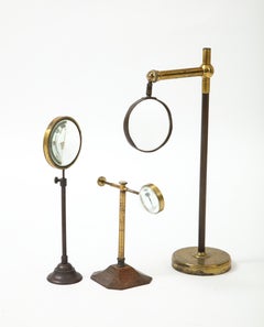 Set of Thee Brass Magnifying Glasses on Stands, early 20th C.
