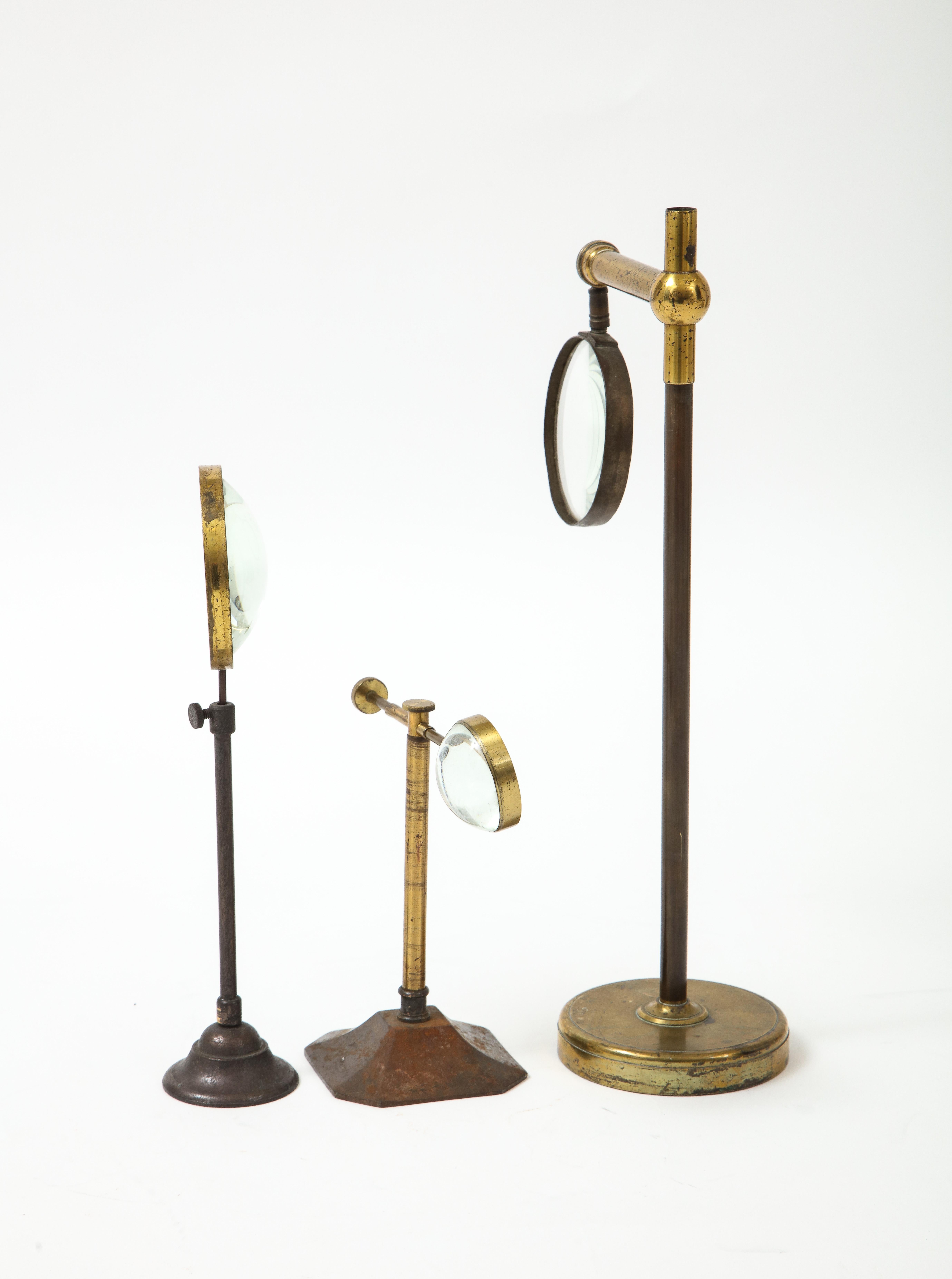 British Set of Thee Brass Magnifying Glasses on Stands, early 20th C.