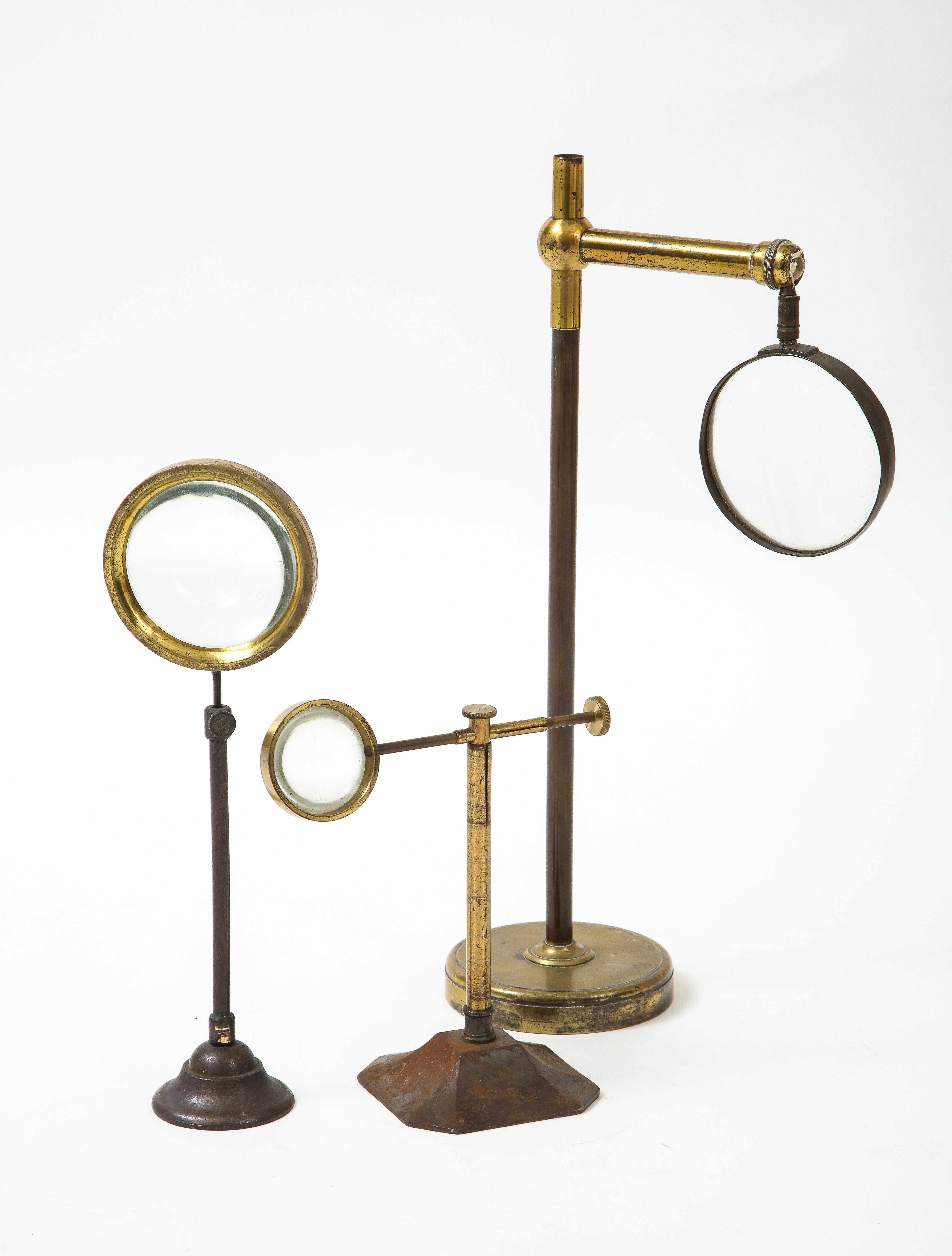 Set of Thee Brass Magnifying Glasses on Stands, early 20th C. In Good Condition In South Salem, NY