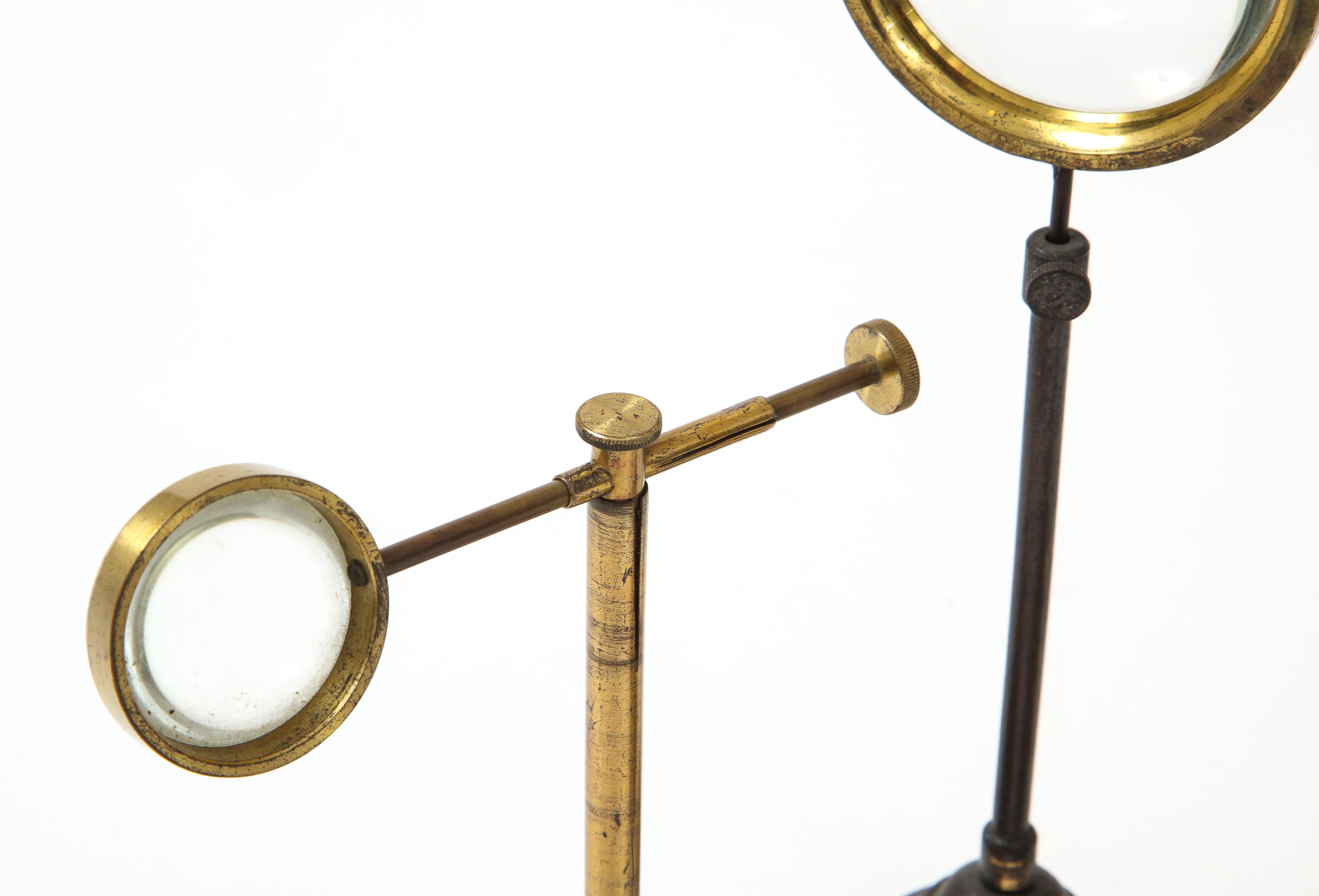 Set of Thee Brass Magnifying Glasses on Stands, early 20th C. 1