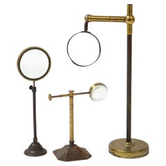 Antique Set of Thee Brass Magnifying Glasses on Stands, early 20th C.