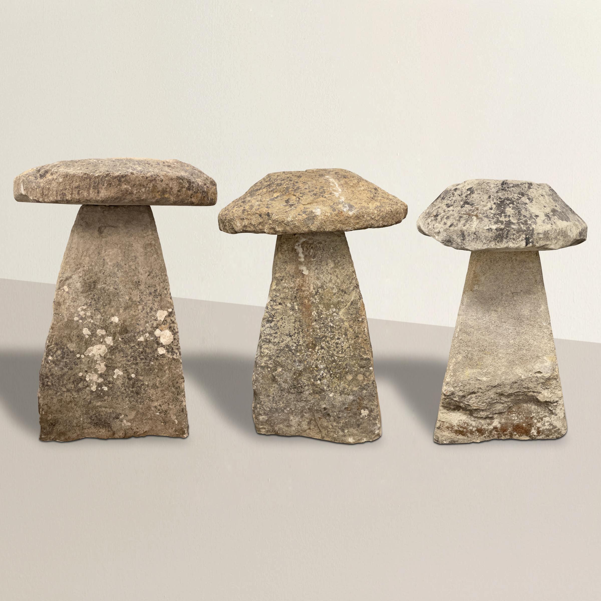 A wonderful set of three 18th century English carved limestone staddle stones with the most wonderful aged surfaces, natural lichens, and wear that only 300 years of use can bestow. Staddle stones were used to elevate granaries off the ground, and