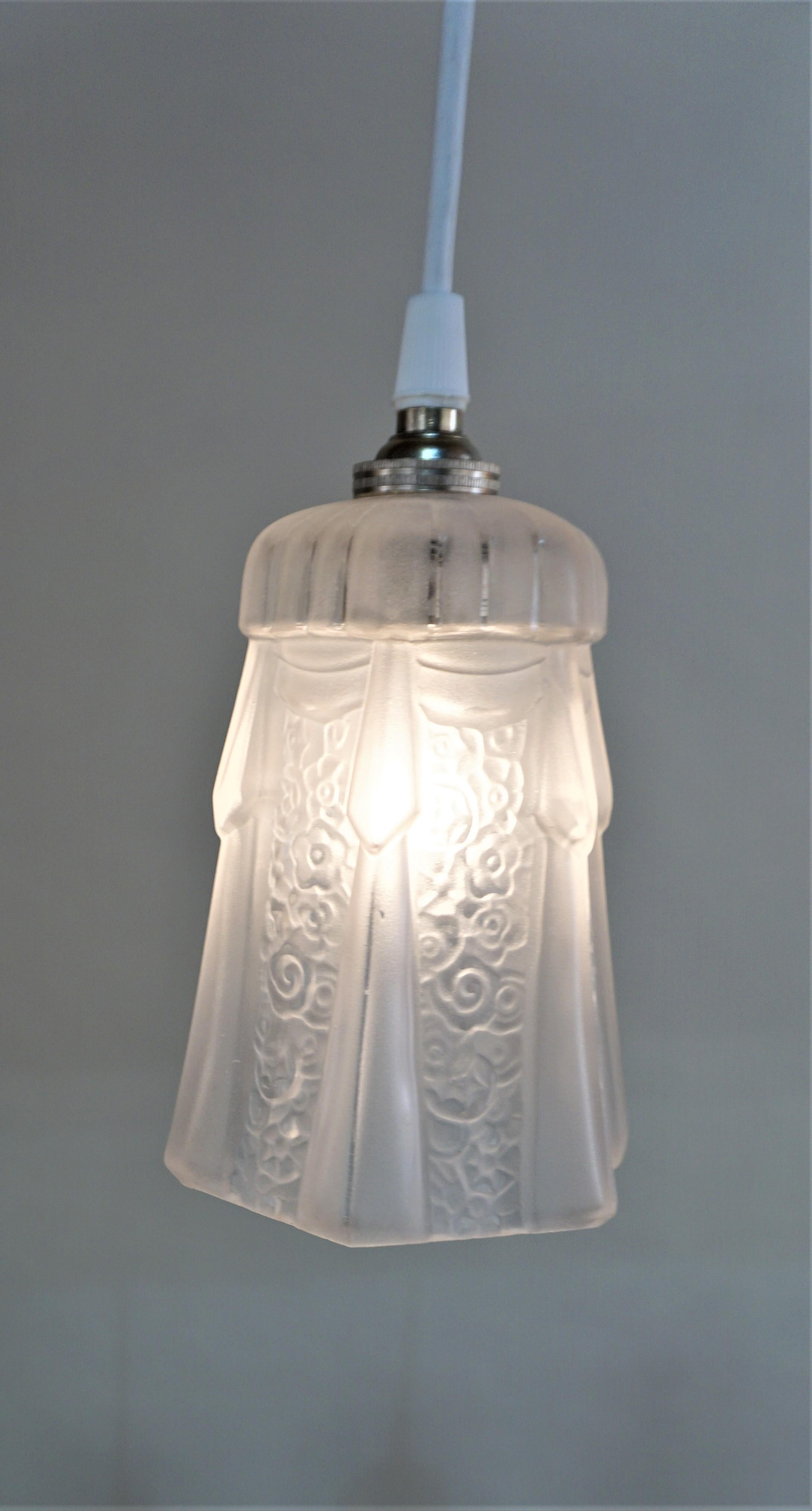Set of three 1930s Art Deco glass shades that have been modified with new white cord and nickel canopy as pendant lights.

Price is for set of 3.