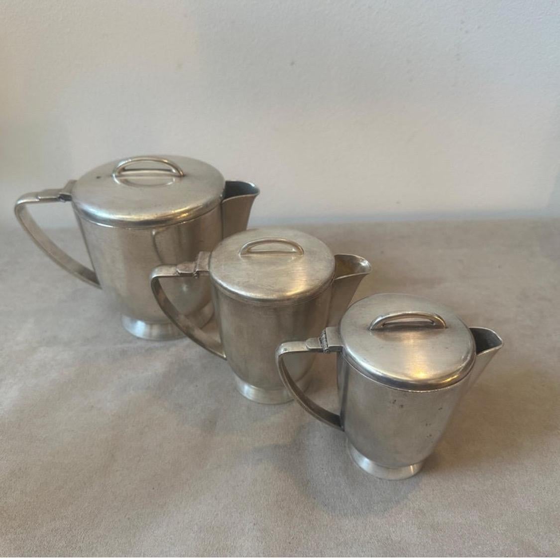 A set of three alpaca coffee pot designed by Gio Ponti and manufactured by Fratelli Calderoni in the Fifties, they were used in the hotels and they are marked on the bottom Calderoni, they are in original conditions with normal signs of use and age.