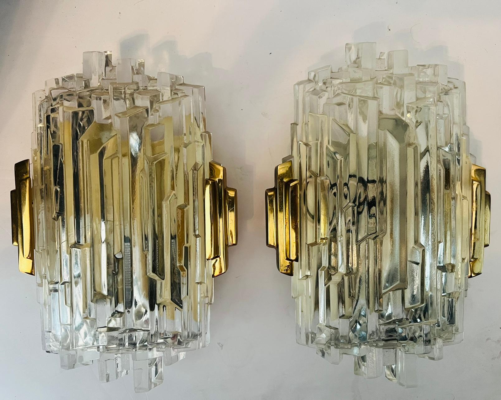 A luxurious set of 3 crystal ice wall lamps composed of golden brass fittings and ice glass shades. Newly rewired with candelabra sockets. Priced individually.