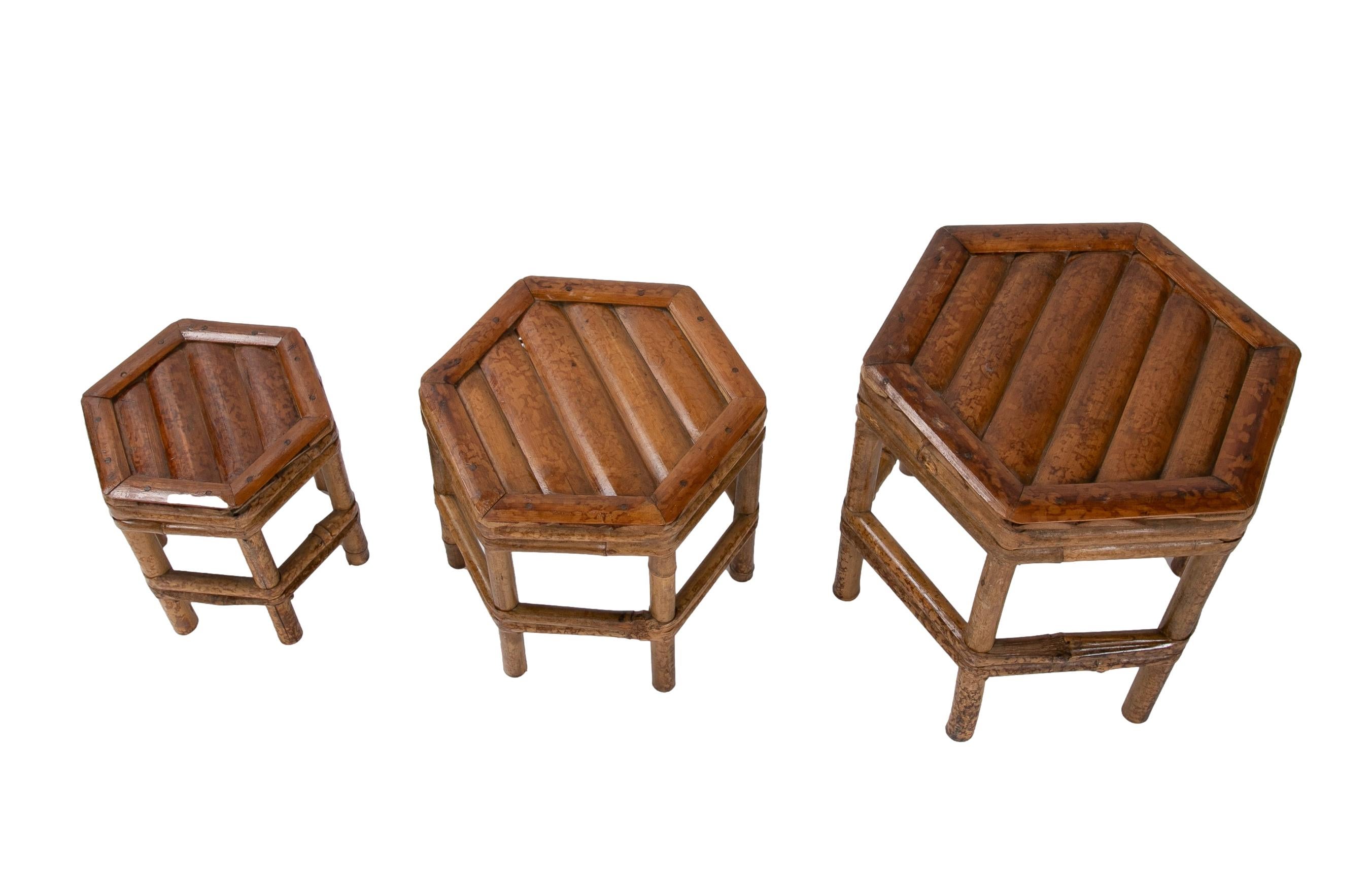 Set of three 1970s Chinese bamboo hexagonal side tables.

Large table size 25x25x25cm.
 