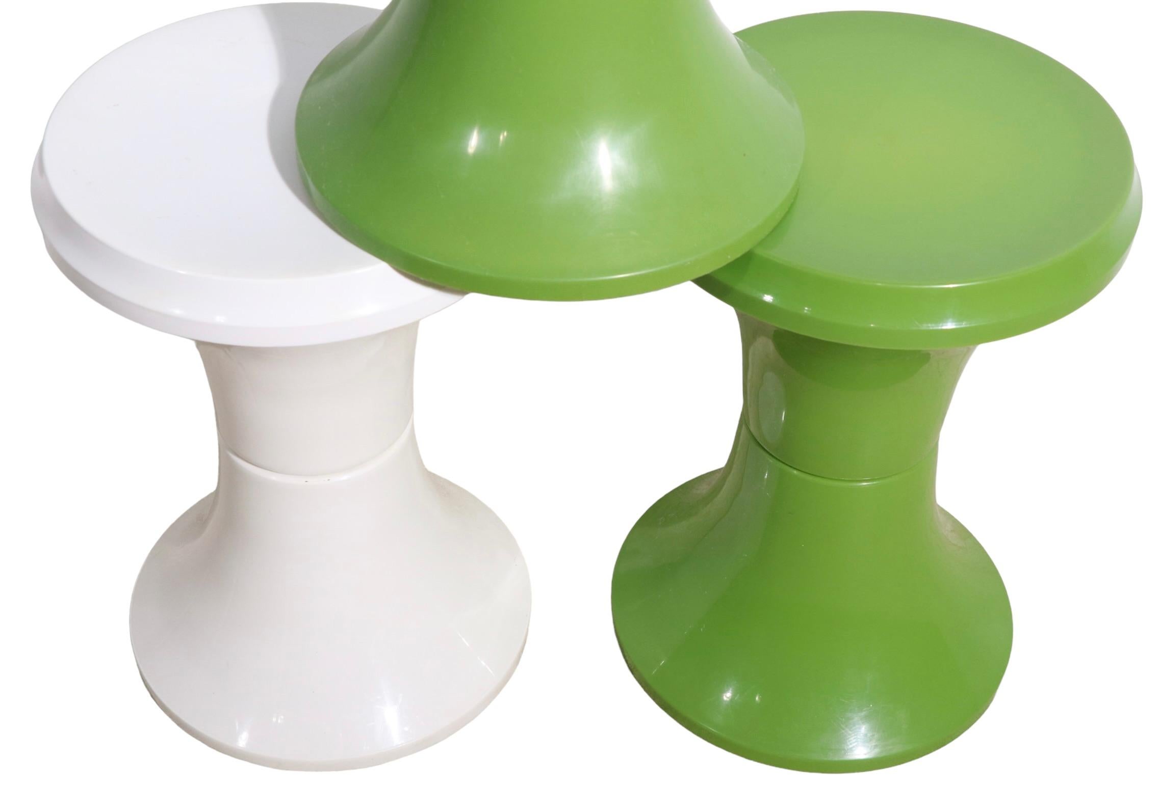 Cool set of three plastic pedestal, end, side table, stools. The set consists of two, green, and one white table, all are in very good, original condition, clean and ready to use. Circa 1970's probably made in Italy. Offered and priced as a set of
