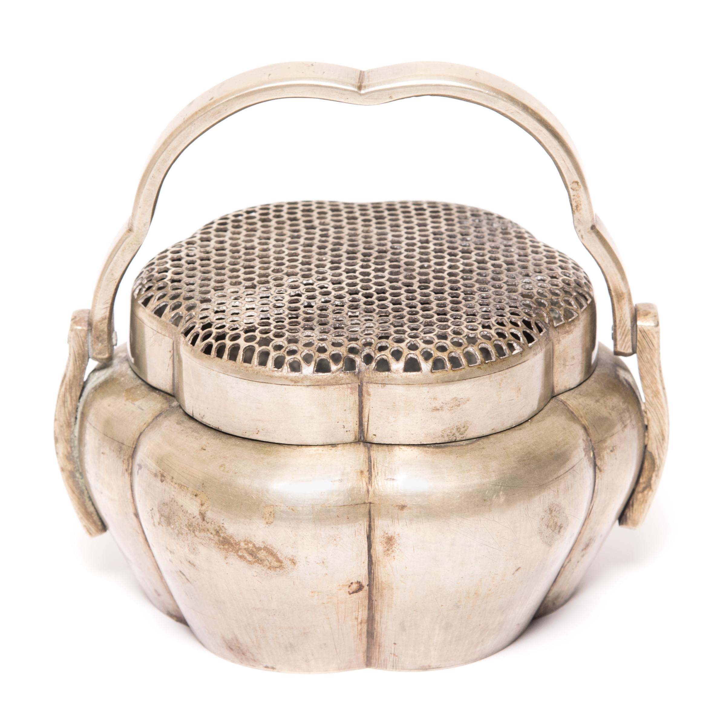 Filled with burning coals, each of these exquisitely crafted 19th century braziers once warmed the cold hands of a wealthy woman on a winter night in Northern China. The precisely pierced lids, designed to let heat waft over cold hands, add texture