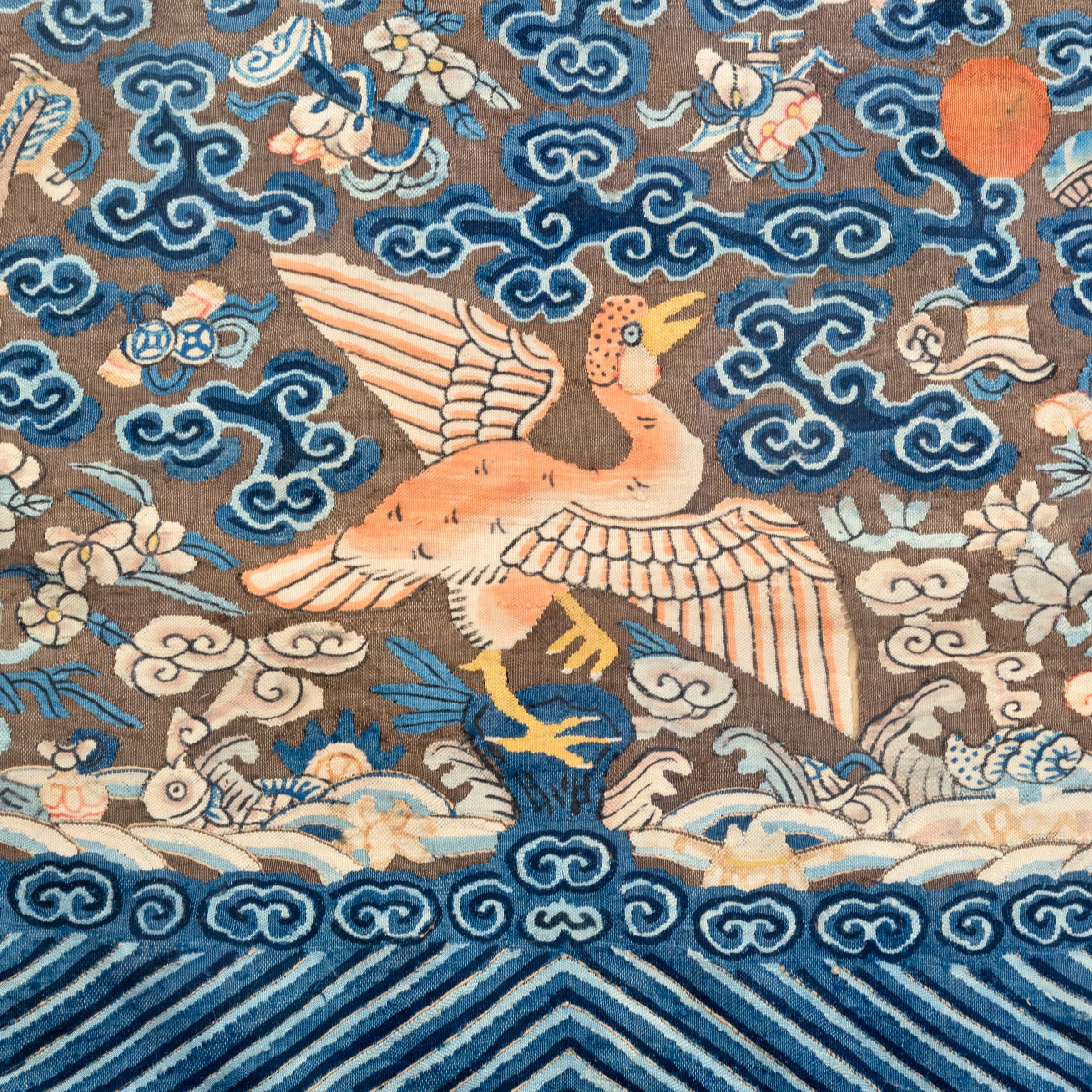 These exquisite, handwoven tapestries are actually Qing-dynasty civil official badges. Such badges were affixed to the front and back of a dark silk overcoat to convey the official's prestige and rank. Facing the sun and resting amidst crashing