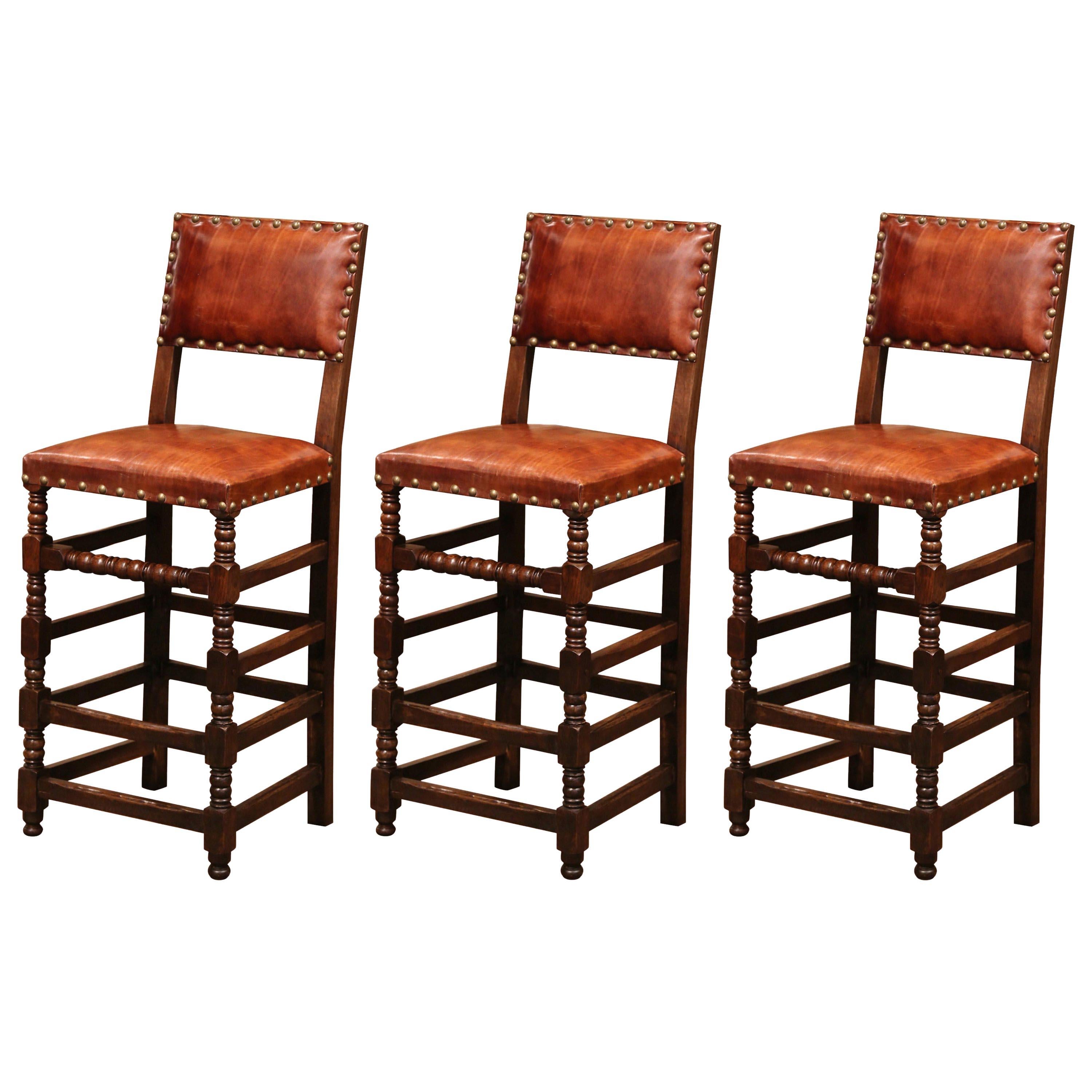 Set of Three 19th Century French Carved Oak and Brown Leather Bar Stools