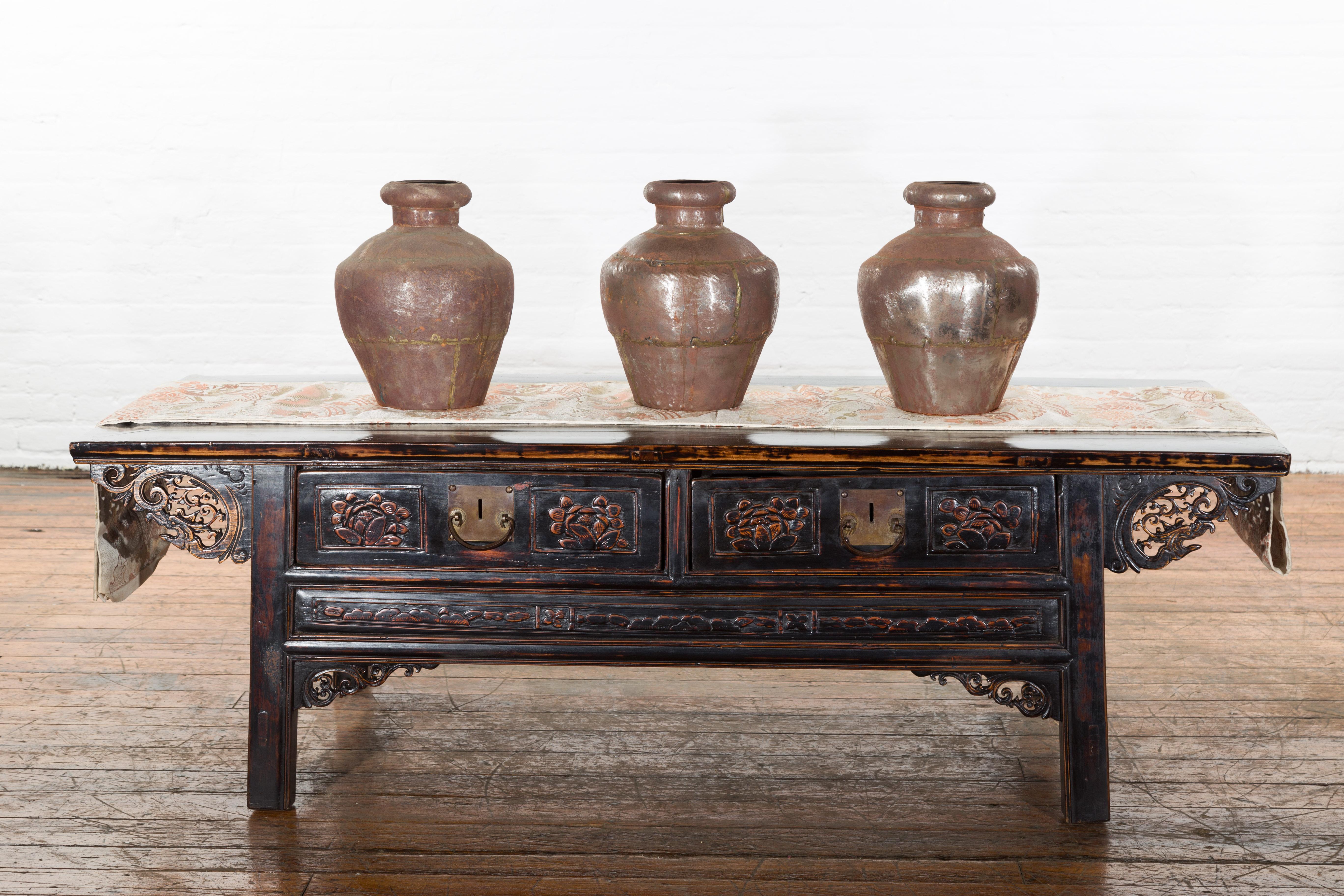 A set of three antique Indian metal vessels from the 19th century with weathered patina. Each of the three antique metal pots feature narrow necks topped with a large lip with a round opening of 4.25