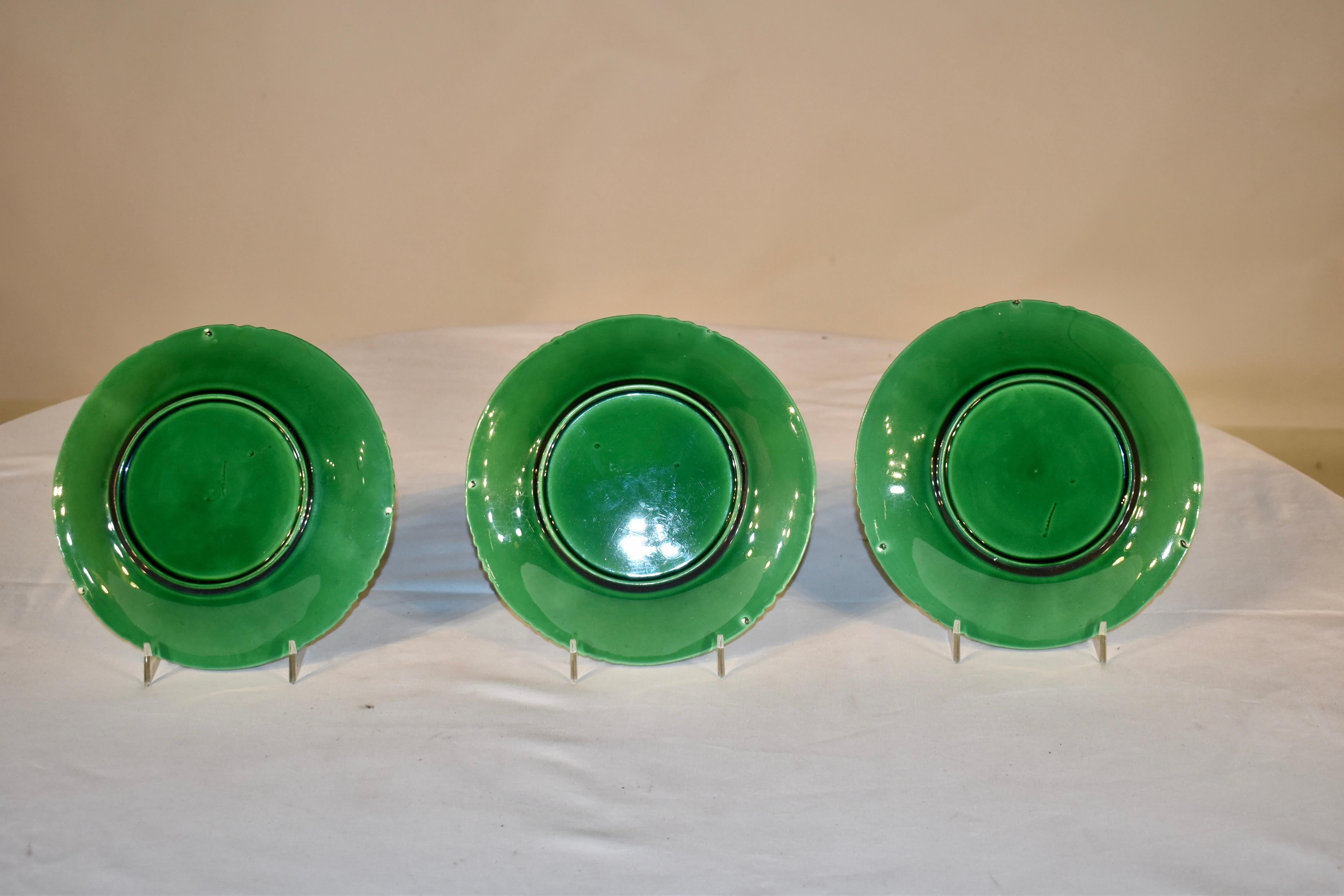 Set of three 19th century majolica leaf plates in a lovely green color. The plates are in a grape leaf pattern, with groupings of grapes on the borders. They are stamped Schramberg on the reverse. Gorgeous color! Plate stands not included.