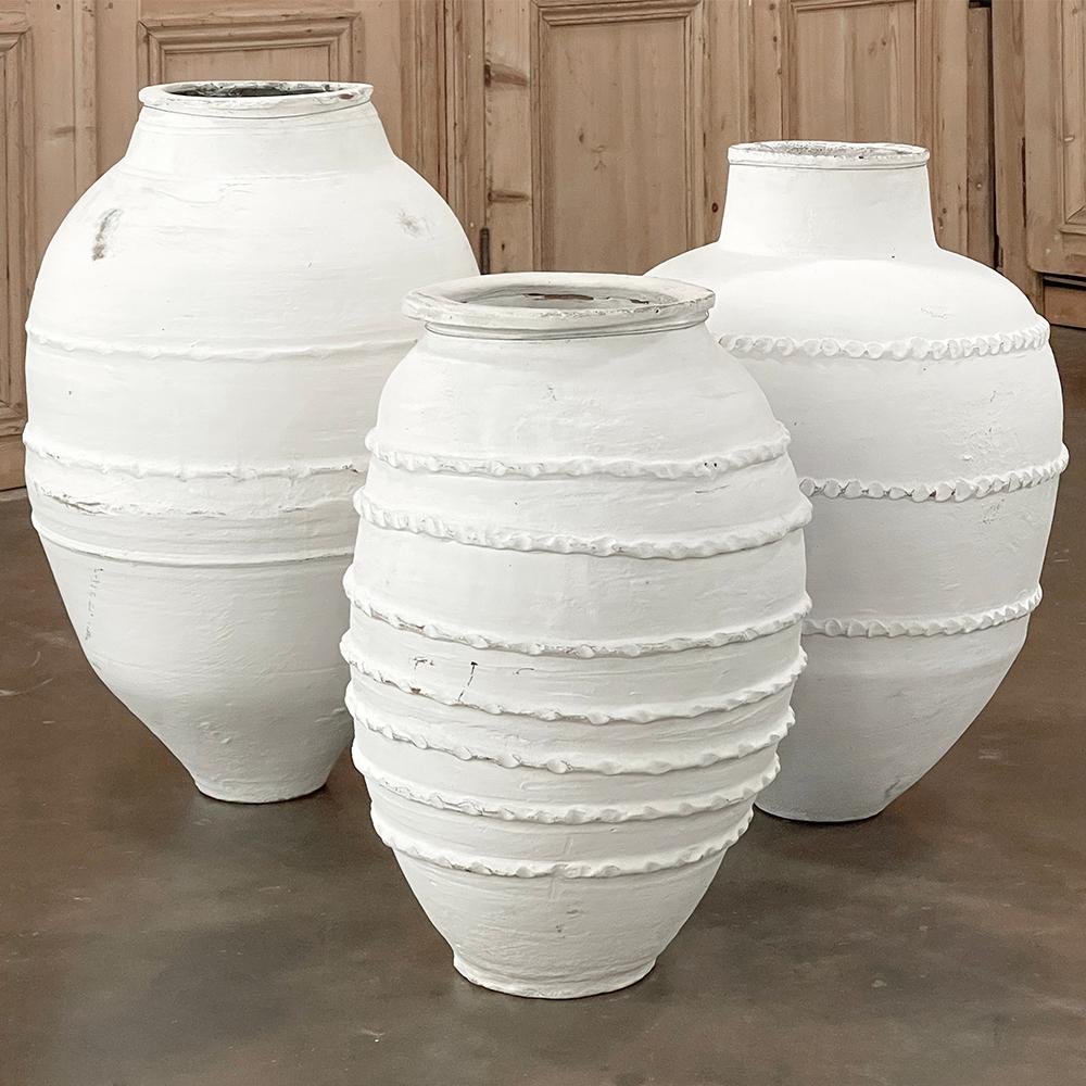 Set of Three 19th Century Painted Greek Earthenware Olive Jars are perfect for adding a timeless touch to your garden, outdoor entertainment area, or even in a casual interior decor!  Hand-thrown and fired from local clays, each features the classic