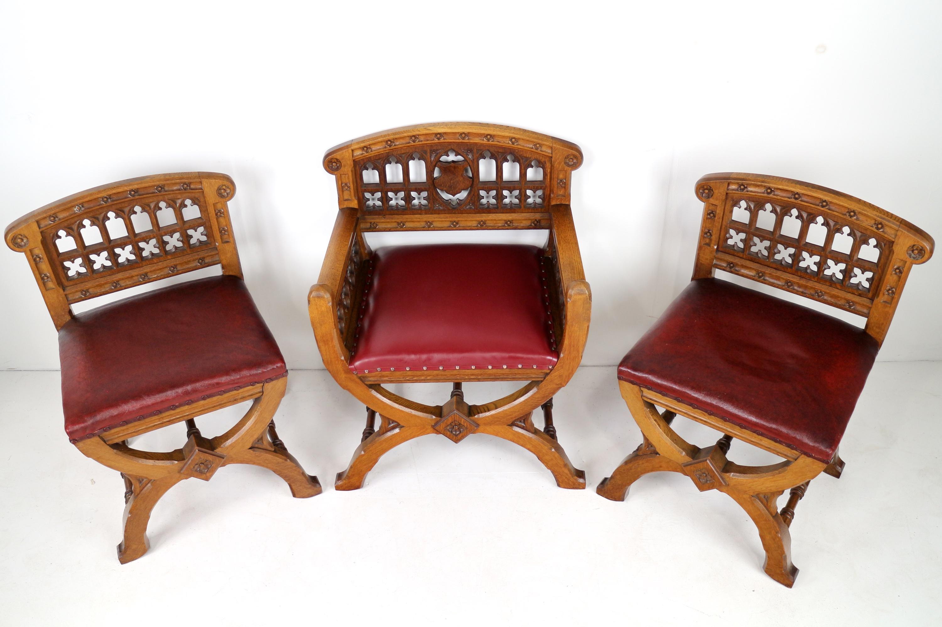 A super set of three Pugin style Gothic Revival church altar or celebrant’s chairs in oak and of curule form from the Priory of St. Scholastica, Atherstone and St Mary’s Abbey, Colwich.  Comprising an armchair and two side chairs with well carved