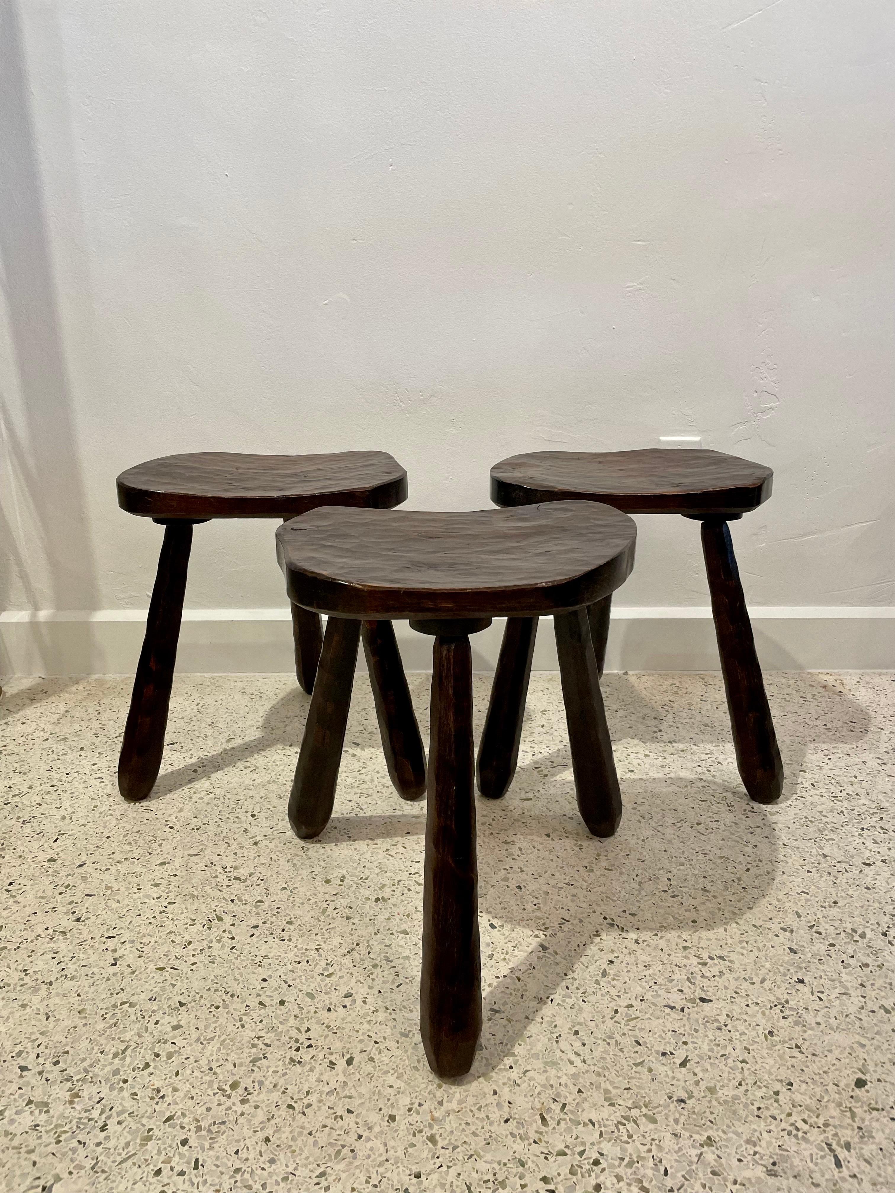 These are a rare set of 3 hand carved dark wood stools, very sturdy and excellent for additional seating.