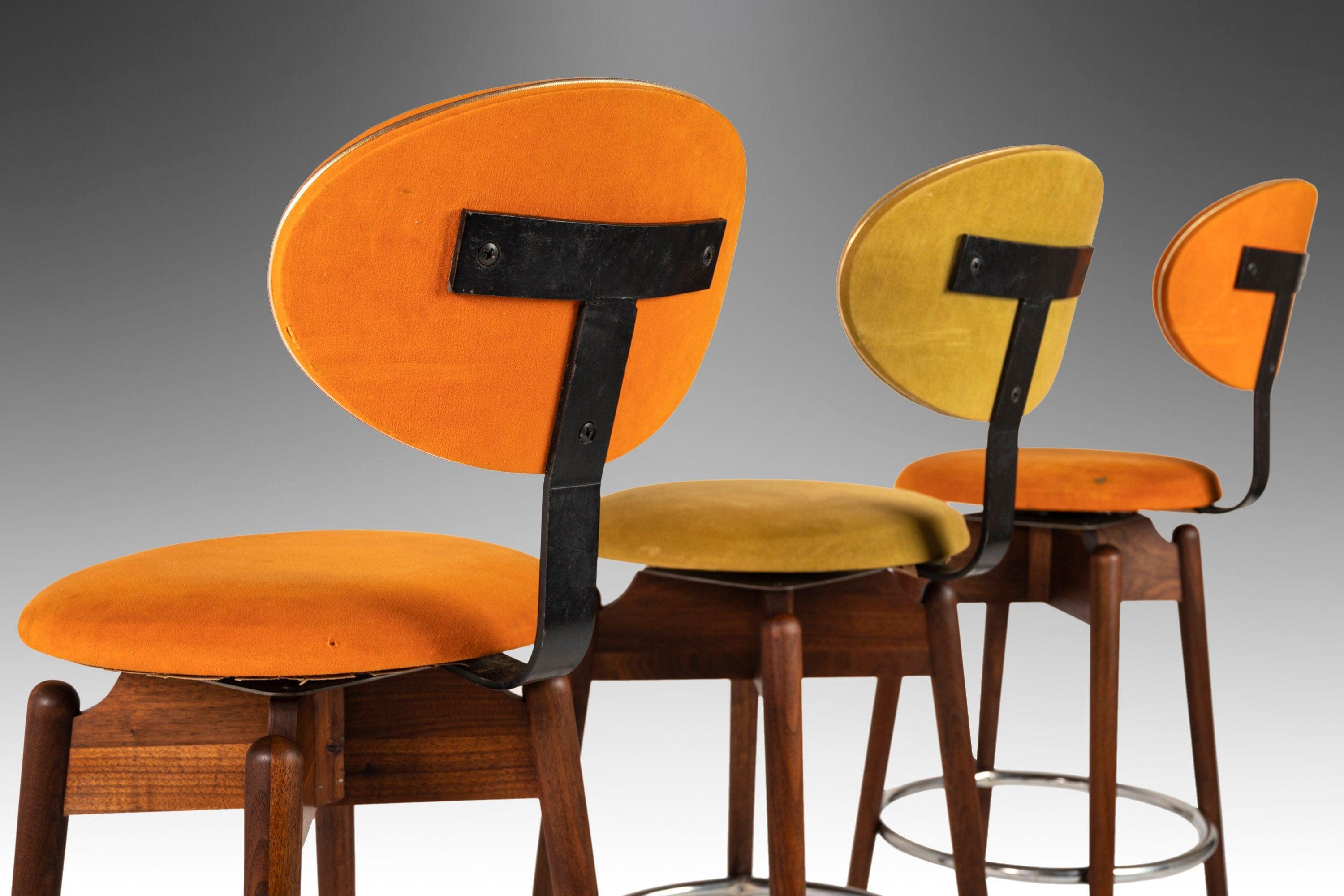 As rare as they are aesthetically captivating this set of barstools, designed by Hugo Frandsen for Spøttrup in the early 1960's, are in 100% original, vintage condition! Constructed of solid walnut with exquisite matchbook joinery and exceptional
