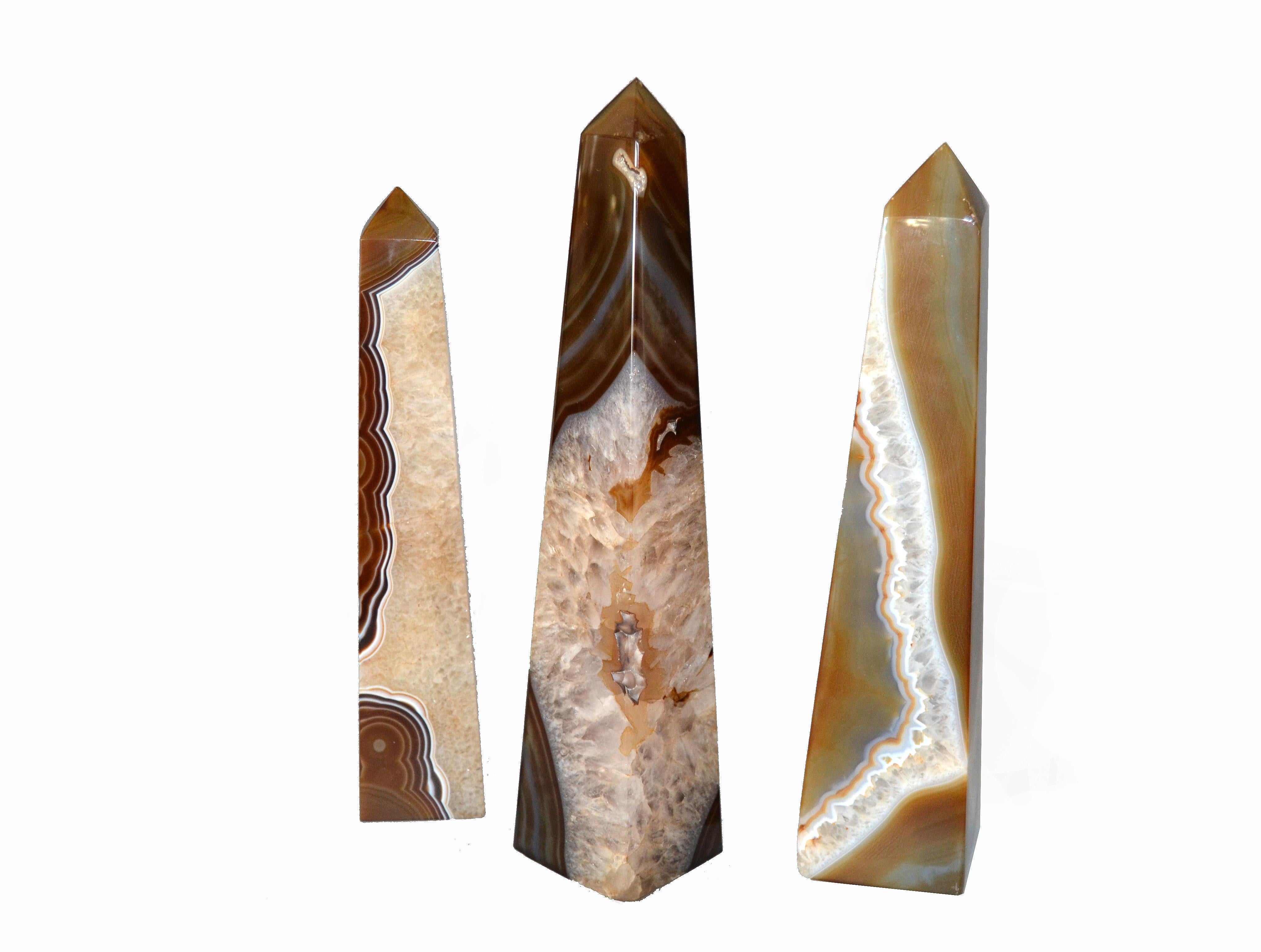 This is a set of three agate Obelisks with amethyst details.
Note the natural banded patterns of these Obelisks.
Simply Beautiful.
Dimensions:
Medium:
Height 11.25 inches, depth 2.75 inches, width 2.75 inches;
Small:
Height 10.5 inches, depth