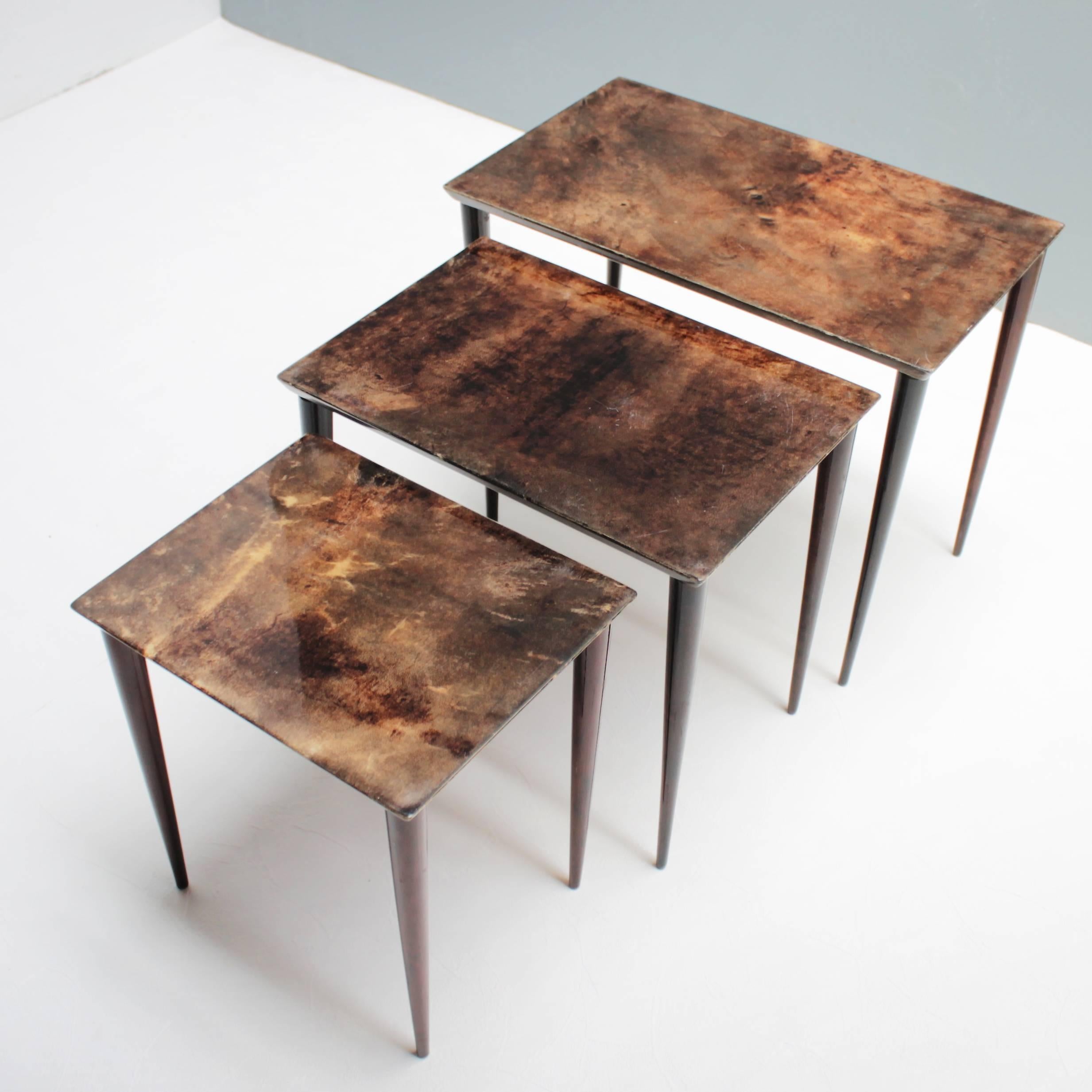 Set of three Aldo Tura nesting tables in lacquered goatskin and mahogany. This particular set was executed, circa 1960 in a somewhat austere style, but - as strong contrast - is covered with a rich brown tanned parchment.
Dimensions: Height: 16.1