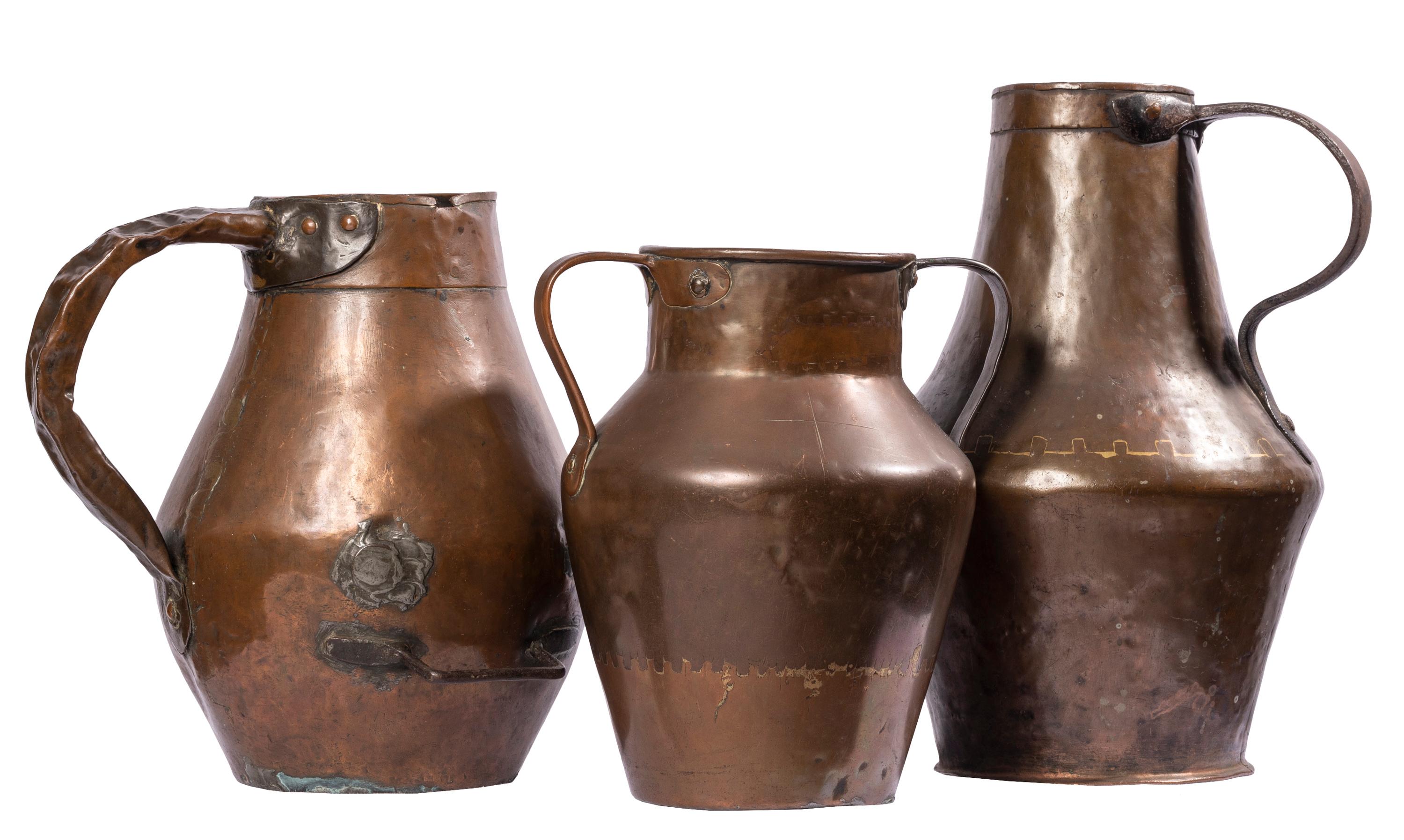 These antique copper containers were hand made in Spain for common household purposes, but with their sculptural forms, rich colors and patina of age they surpass their rough beginnings to become things of beauty.  
   All three show evidence of