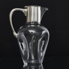 Pinched glass wine jug with silver mounts