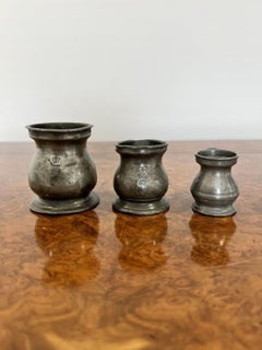 Set of three antique Victorian pewter measures marked VR
