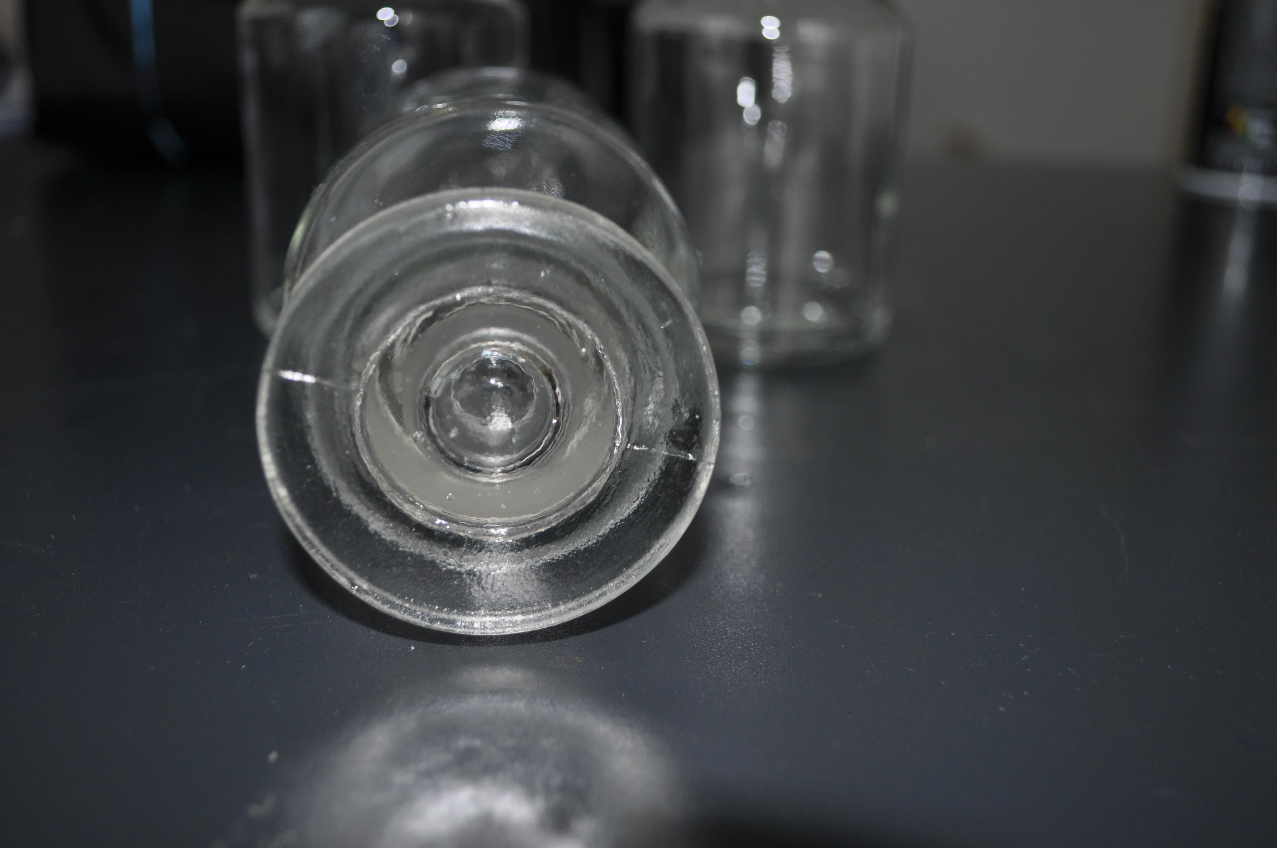 Set of three apothecary glass bottles with stoppers.