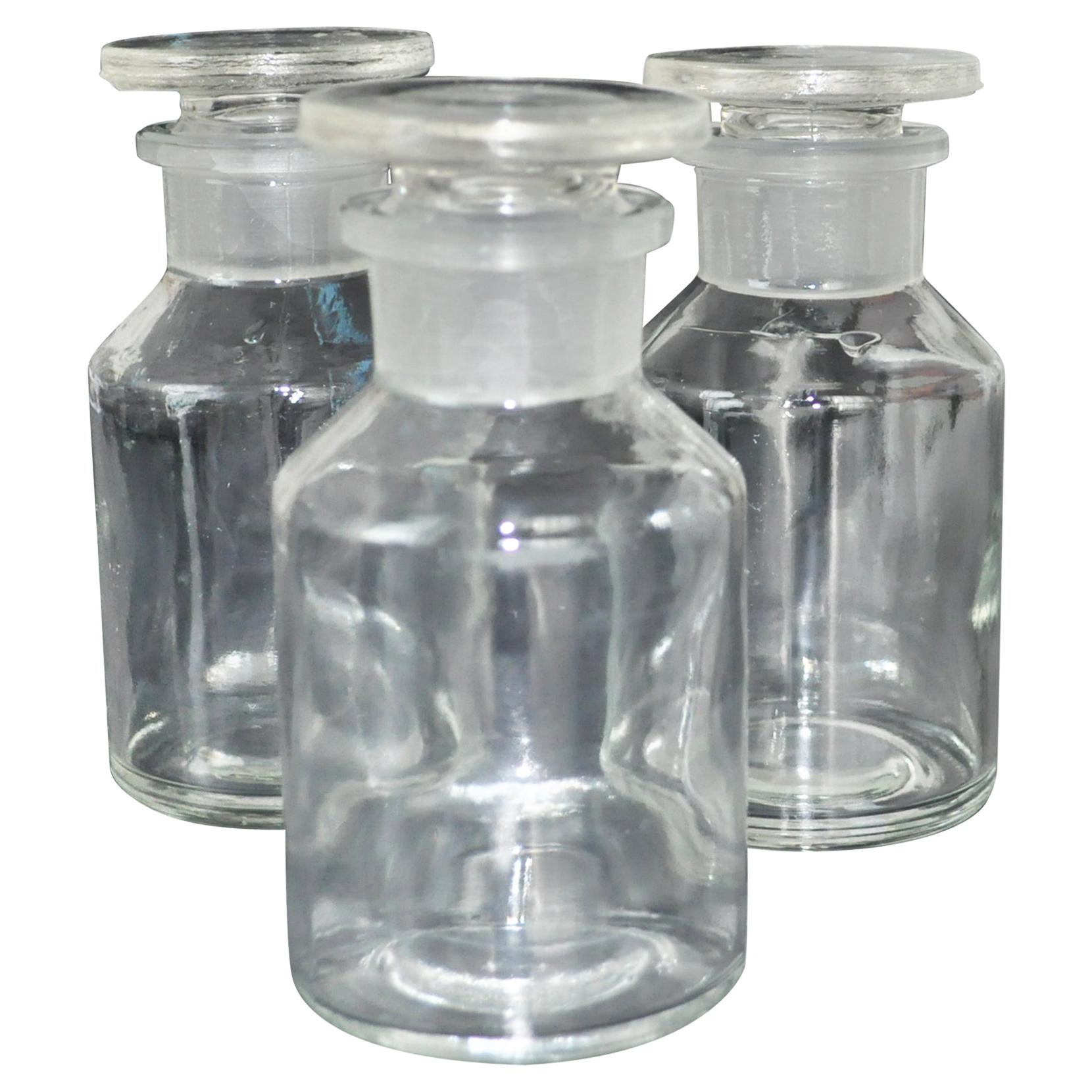 Set of Three Apothecary Glass Bottles with Stoppers For Sale