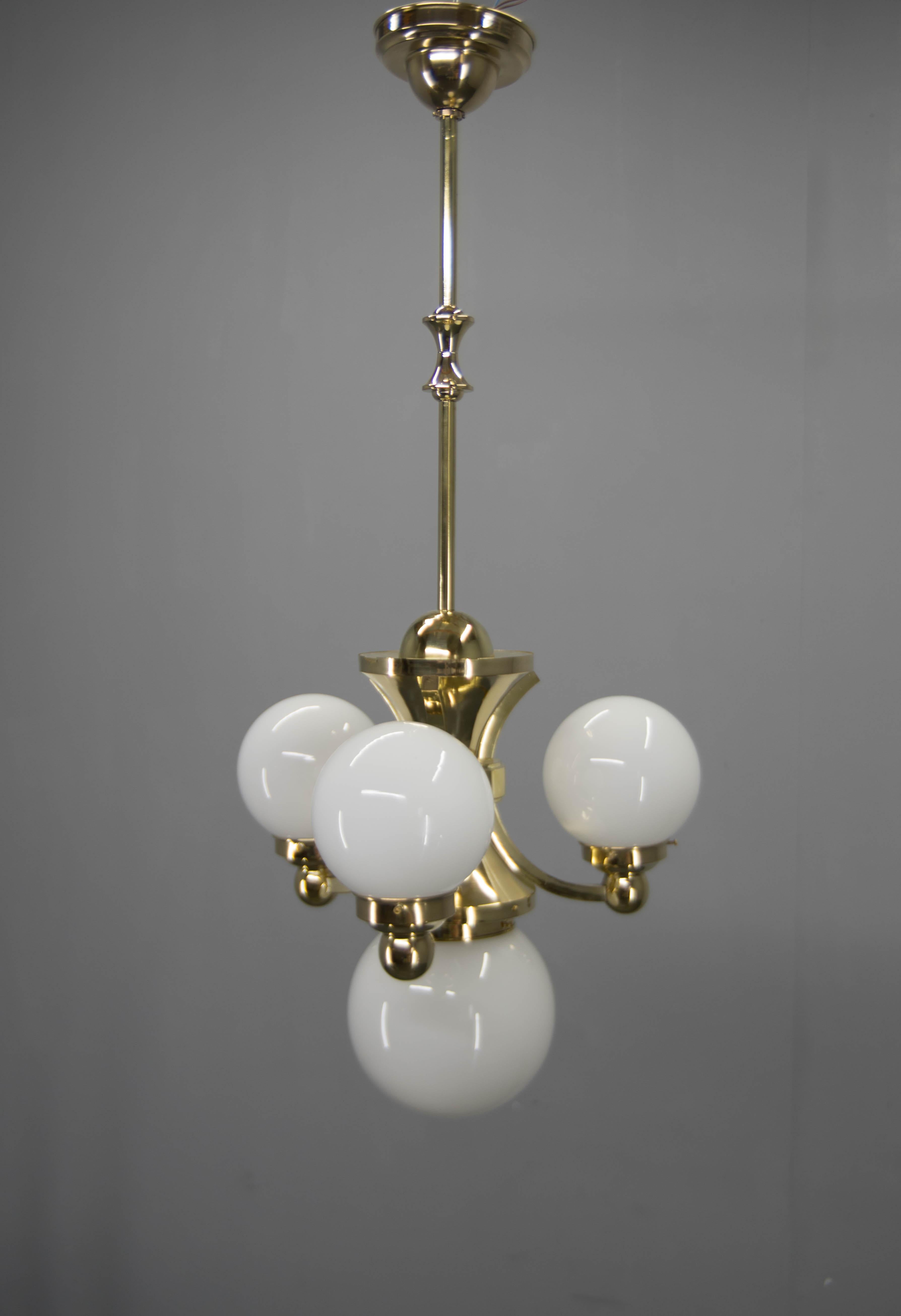 Very rare set of three chandeliers in Rondocubist manner used in iconic rondocubistic buildings by Josef Gocar in Prague. 
Brass refinished, items rewired. US wiring compatible.
Two-flamming fixture - Height: 95 cm, Width: 44 cm, Depth: 13