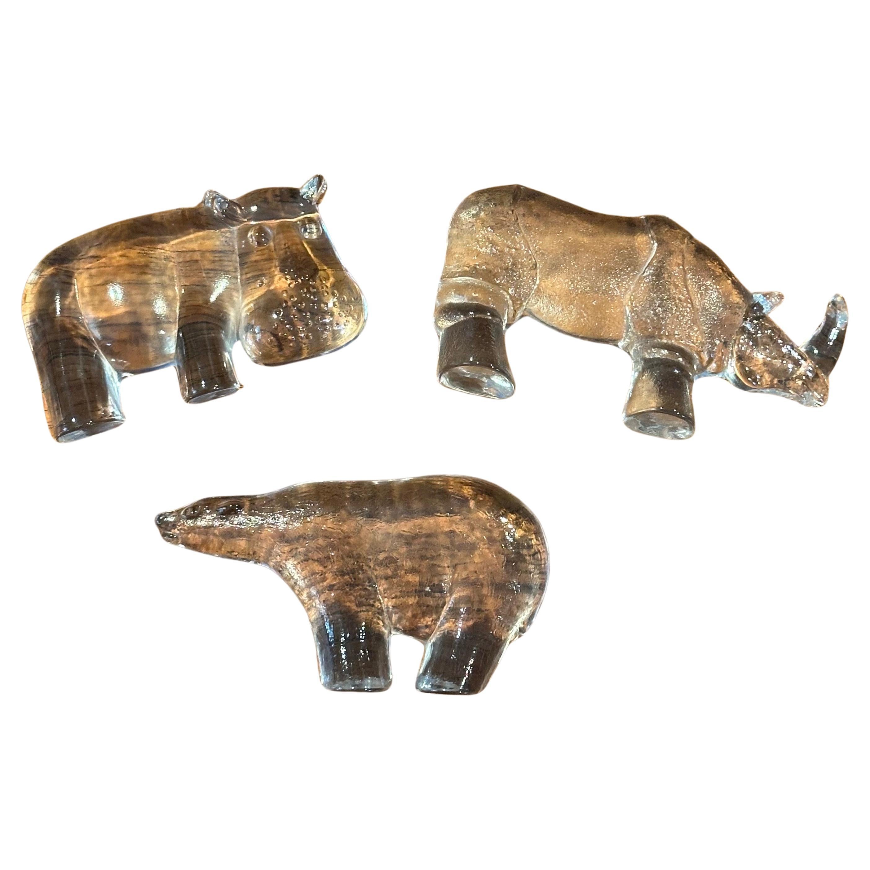 A very set of three art glass animal  paperweights / sculptures by Kosta Boda Sweden, circa 1980s. The set includes a hippo, rhino and polar bear.  They are in very good vintage condition with no chips or cracks and measures approximately 5