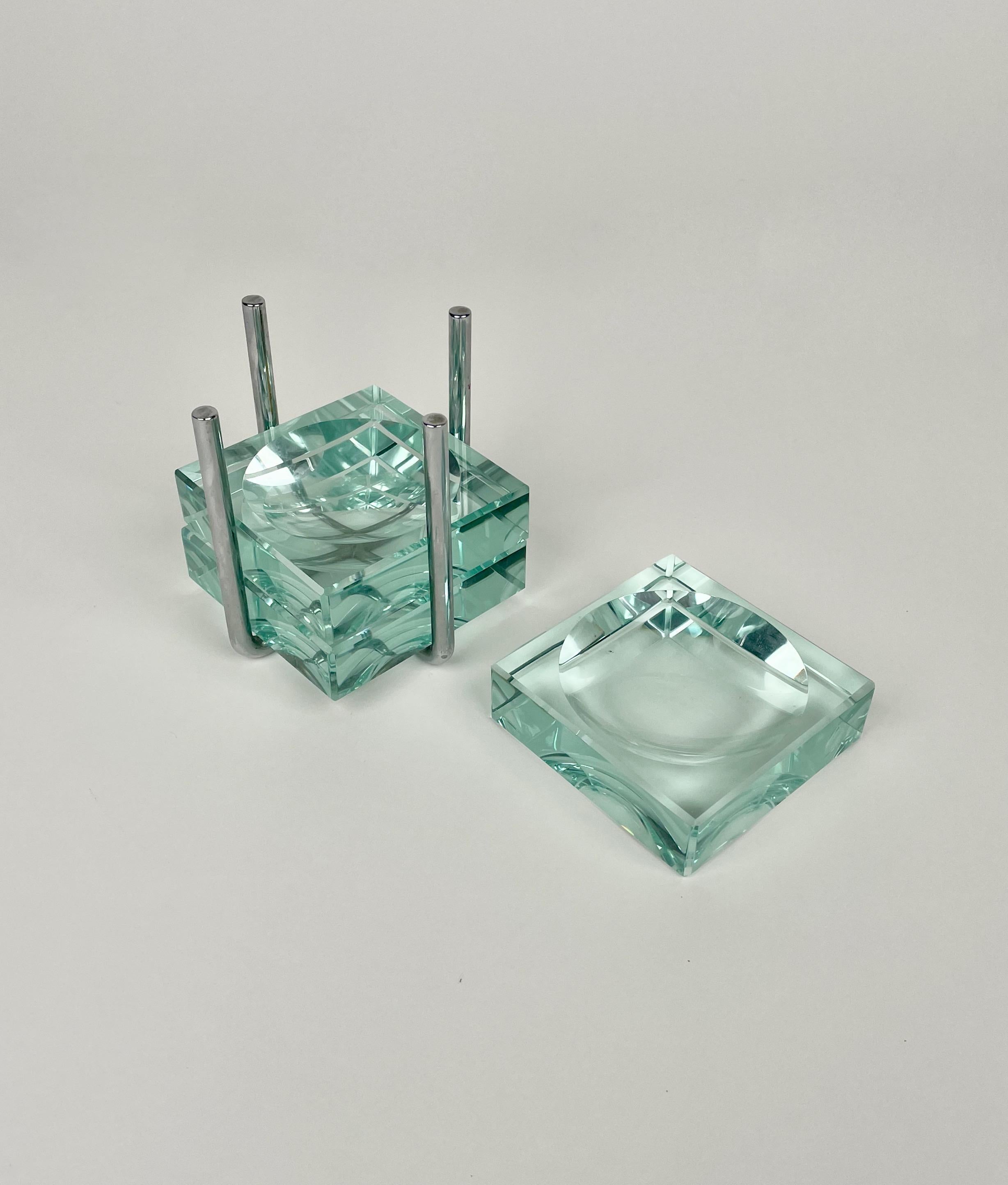 Set of three ashtrays in aquamarine glass coming with their steel holding structure. Designed by Gallotti & Radice in the 1970s, Italy.