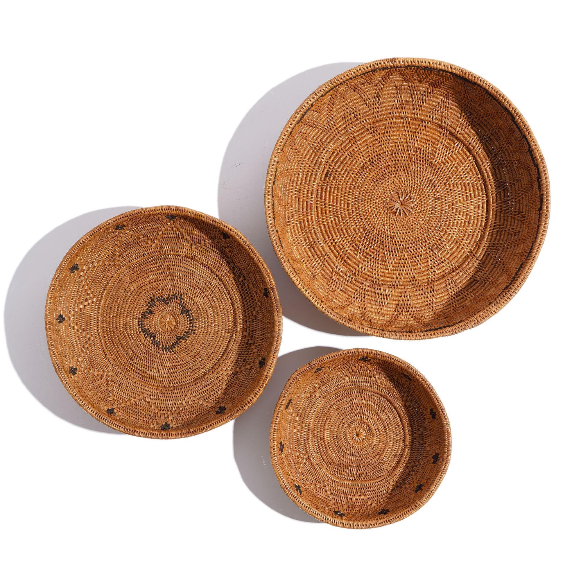 Nest of three woven grass shallow baskets with contrasting blackened grass decorative elements.

Dimensions: 7-1/2