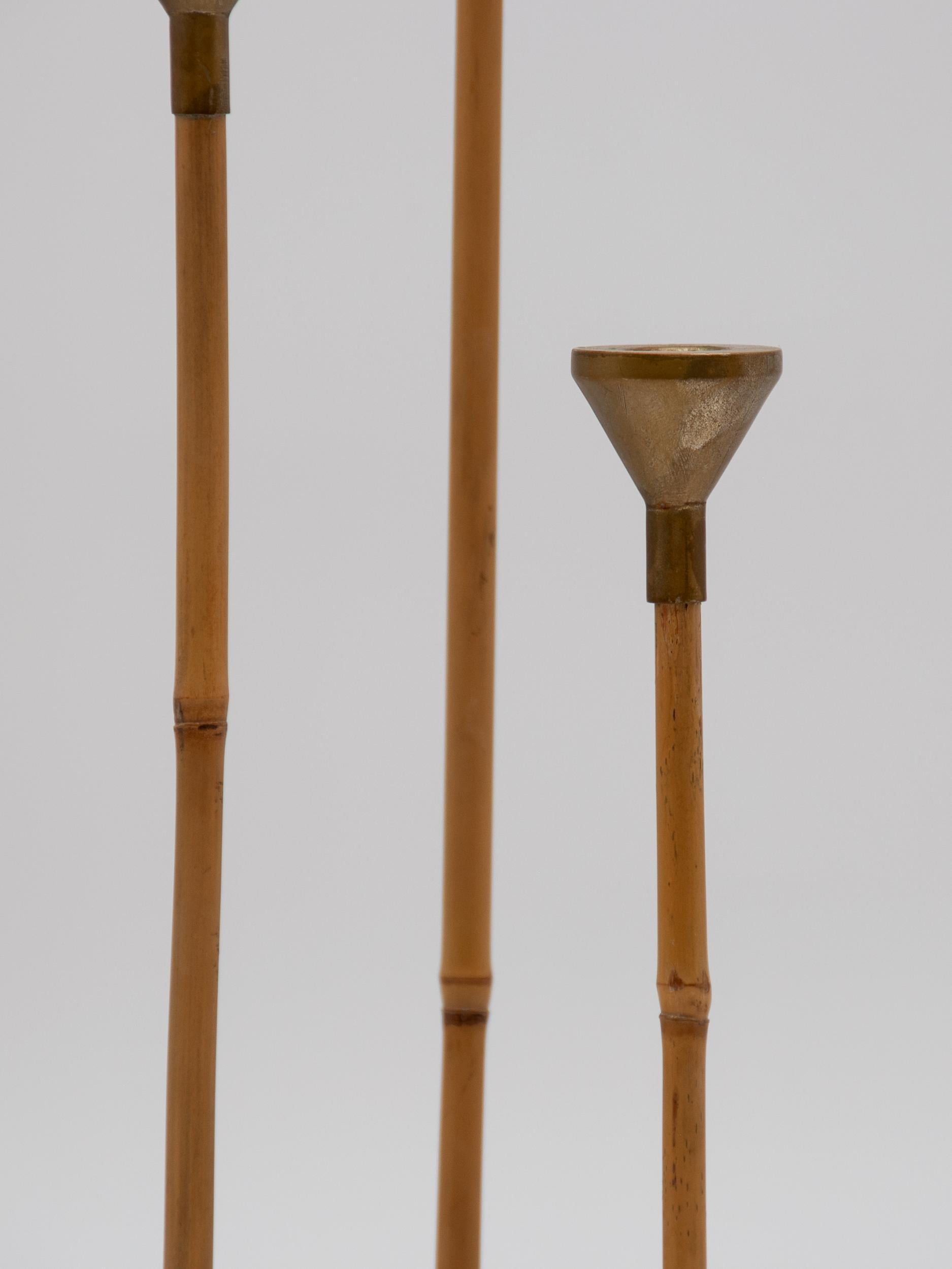 Set of three delicate bamboo and brass candlesticks. Contemporary and originally sold through Bergdorf Goodman. 19.5