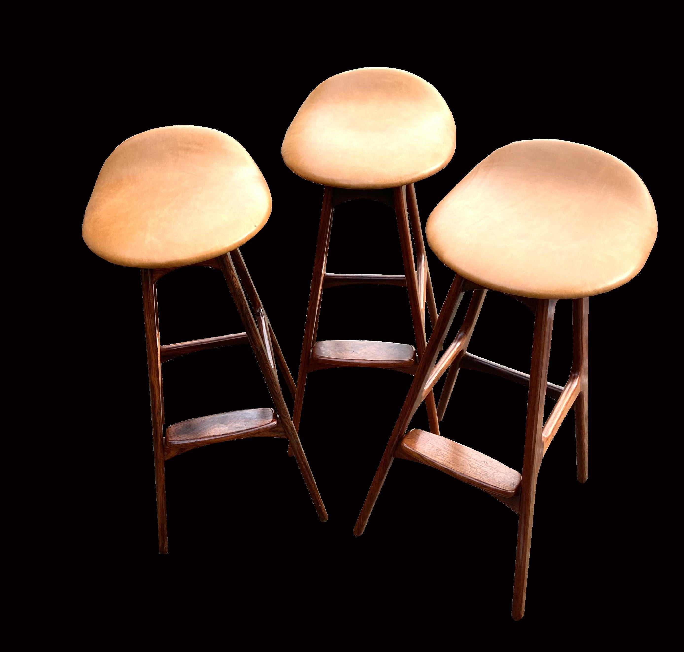 A lovely set of three of these most classic of barstools designed by Erik Buch, or Buck as it is sometimes attributed, produced by O.D. Mobler, these are in Pau Ferro (solid Santos Rosewood ) latin name Machaerium Scleroxylon, and because they are